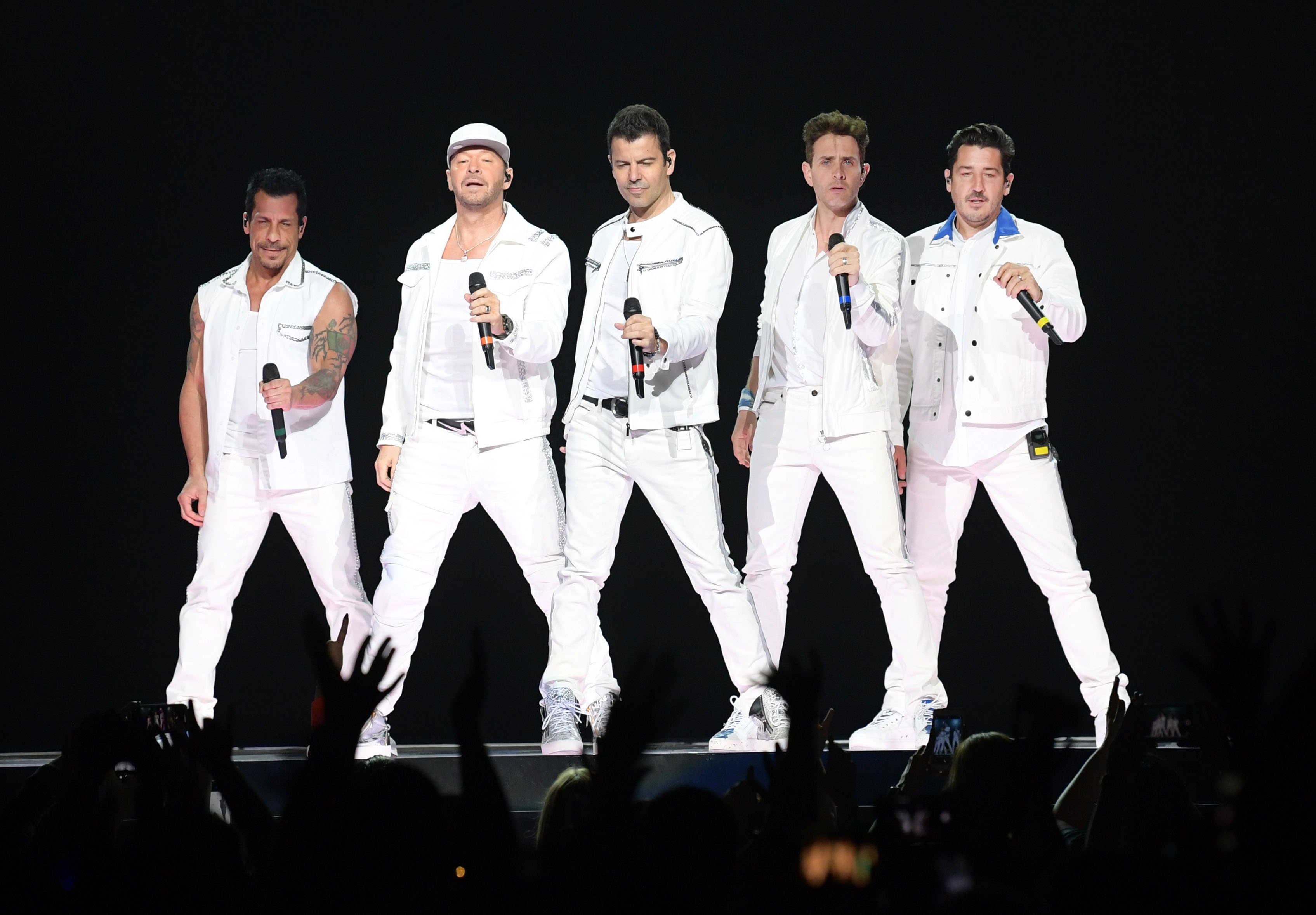 (L-R): Danny Wood, Donnie Wahlberg, Jordan Knight, Joey McIntyre and Jonathan Knight of the musical group NKOTB performing onstage
