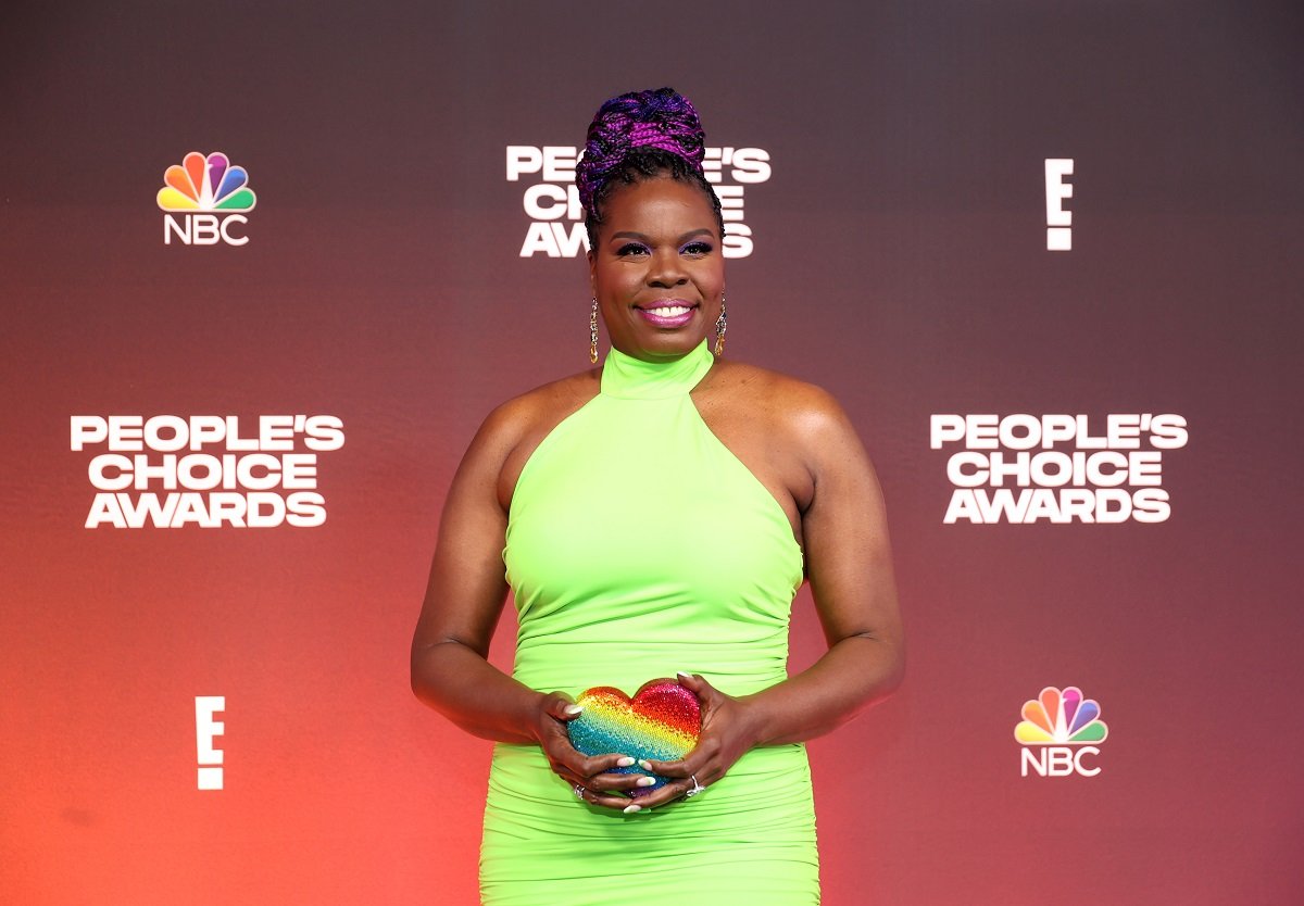 Leslie Jones smiling while wearing a green dress.