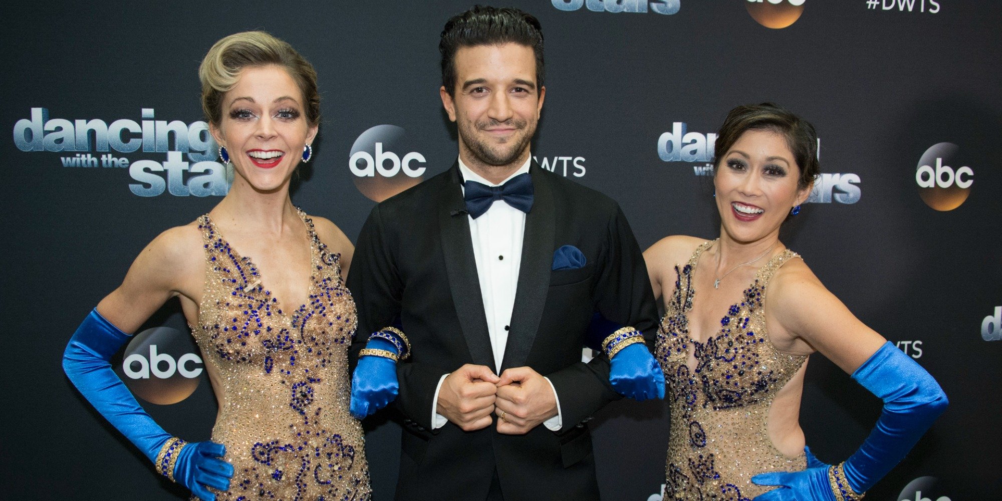 Lindsay Stirling, Mark Ballas, and Kristi Yamaguchi pose together.