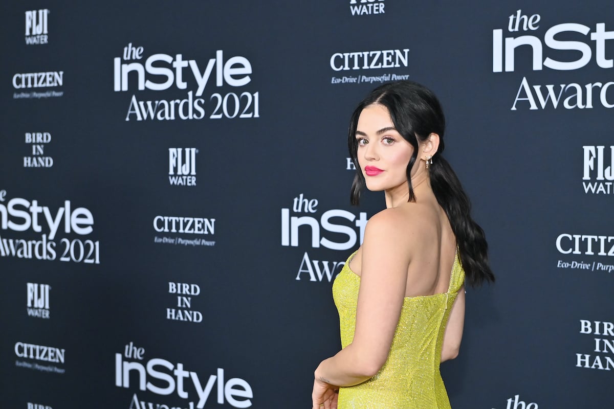 Pretty Little Liars alum Lucy Hale looks over her shoulder in a yellow dress