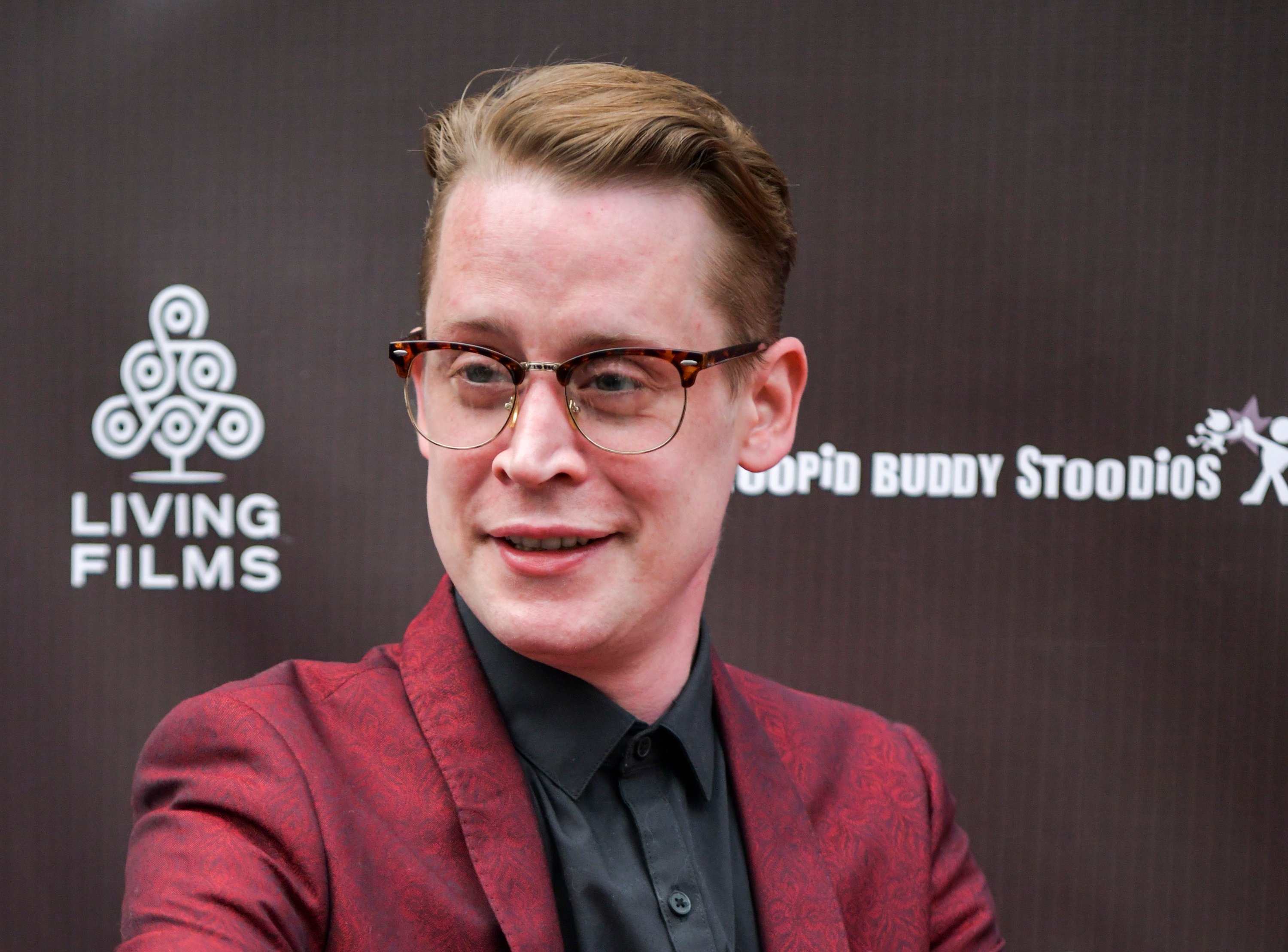Macaulay Culkin smiling for photographers at the LA premiere of 'Changeland'