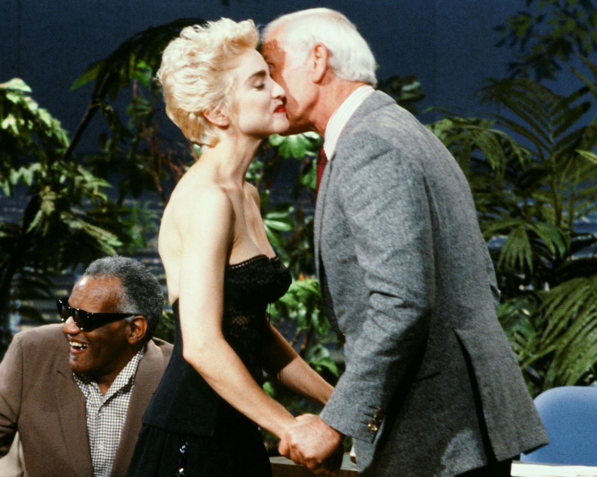 Madonna in a black bustier, receive a kiss on the cheek from Johnny Carson c. 1987
