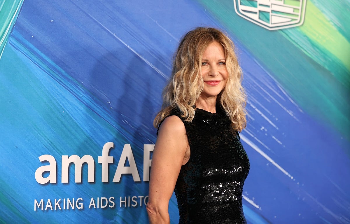 Meg Ryan smiling in a black dress