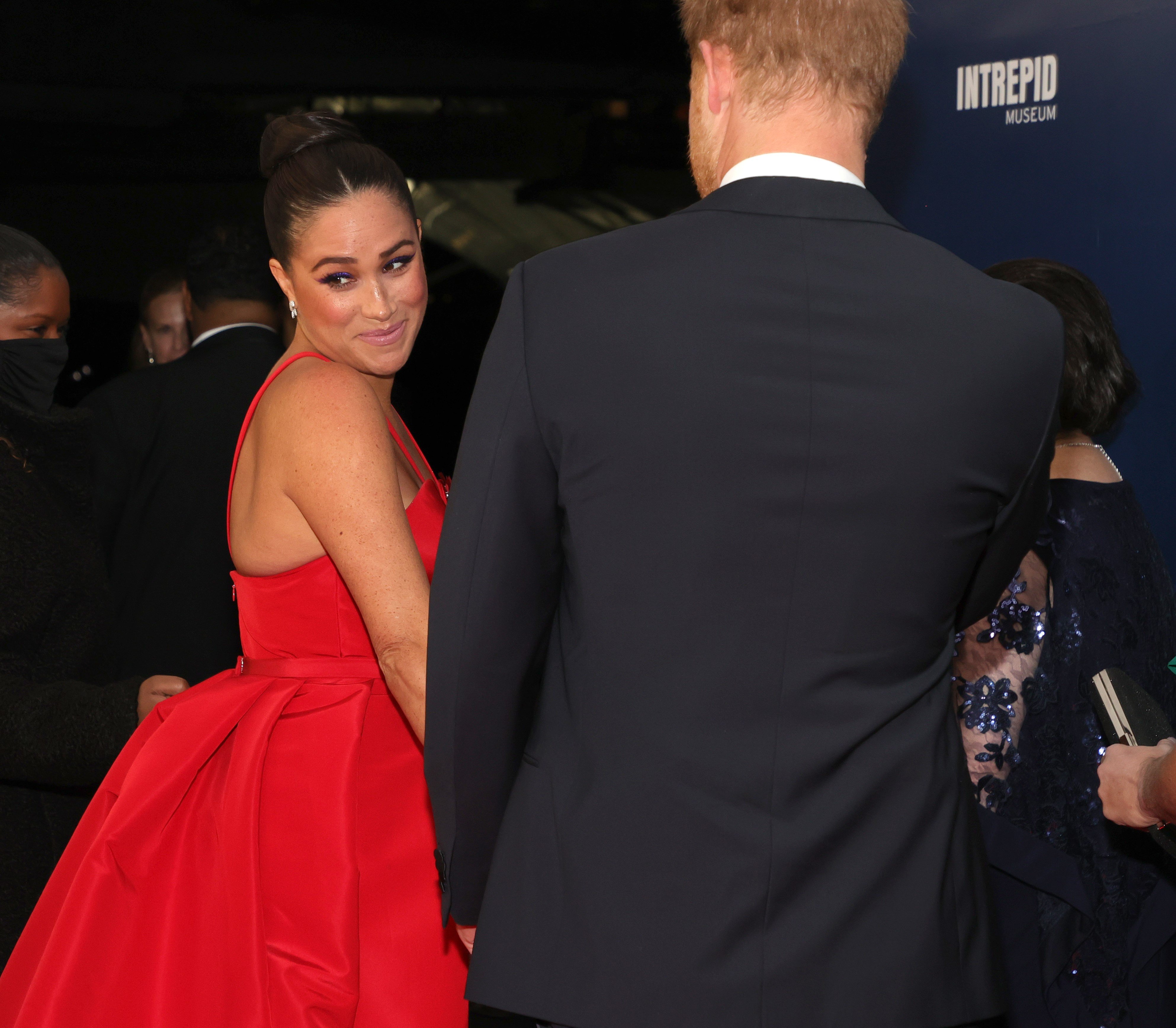 Meghan Markle looking over her shoulder and smiling at the Salute To Freedom Gala in NYC