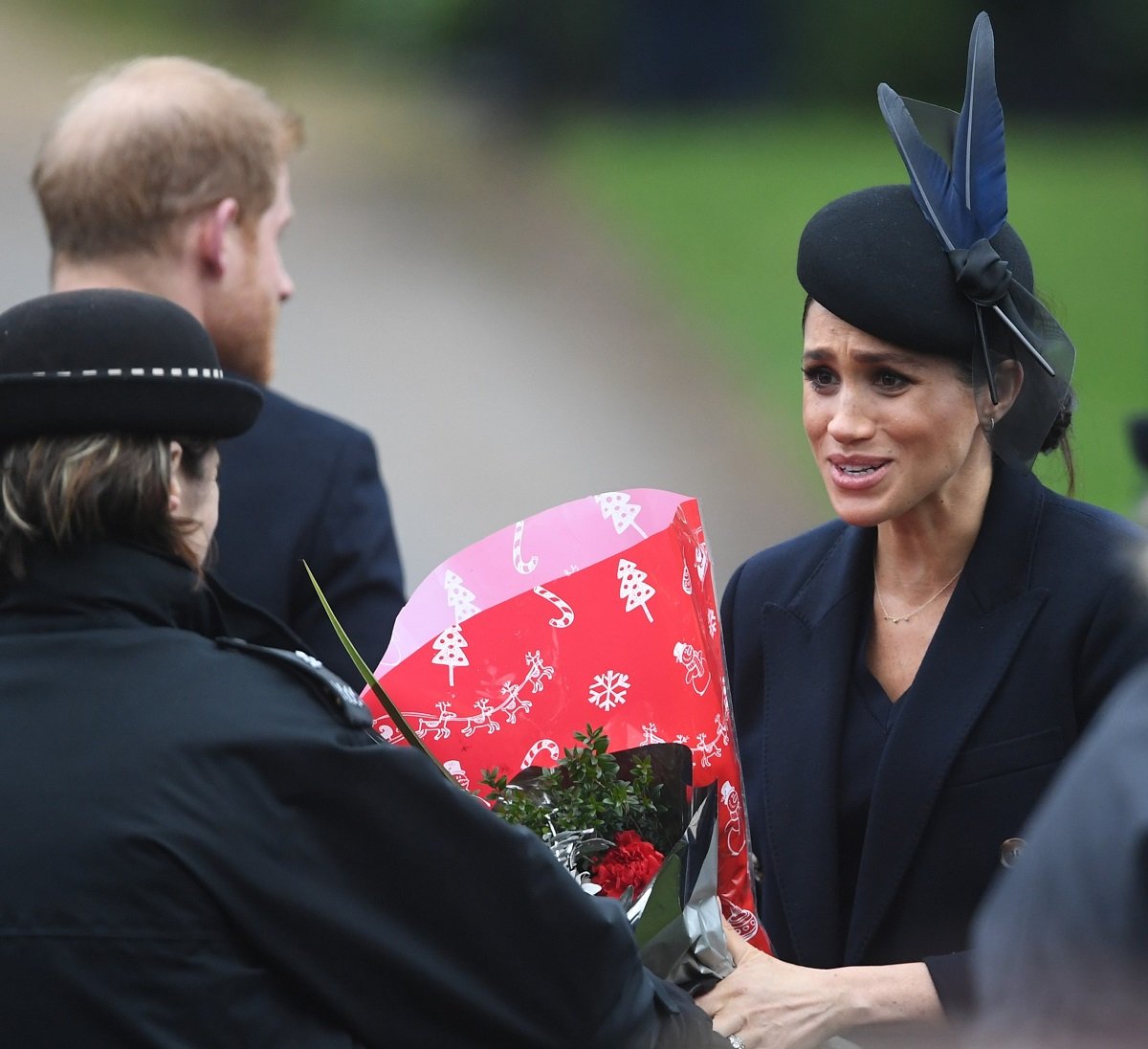 Meghan Markle receiving a bouquet as she arrives for church service on Christmas Day