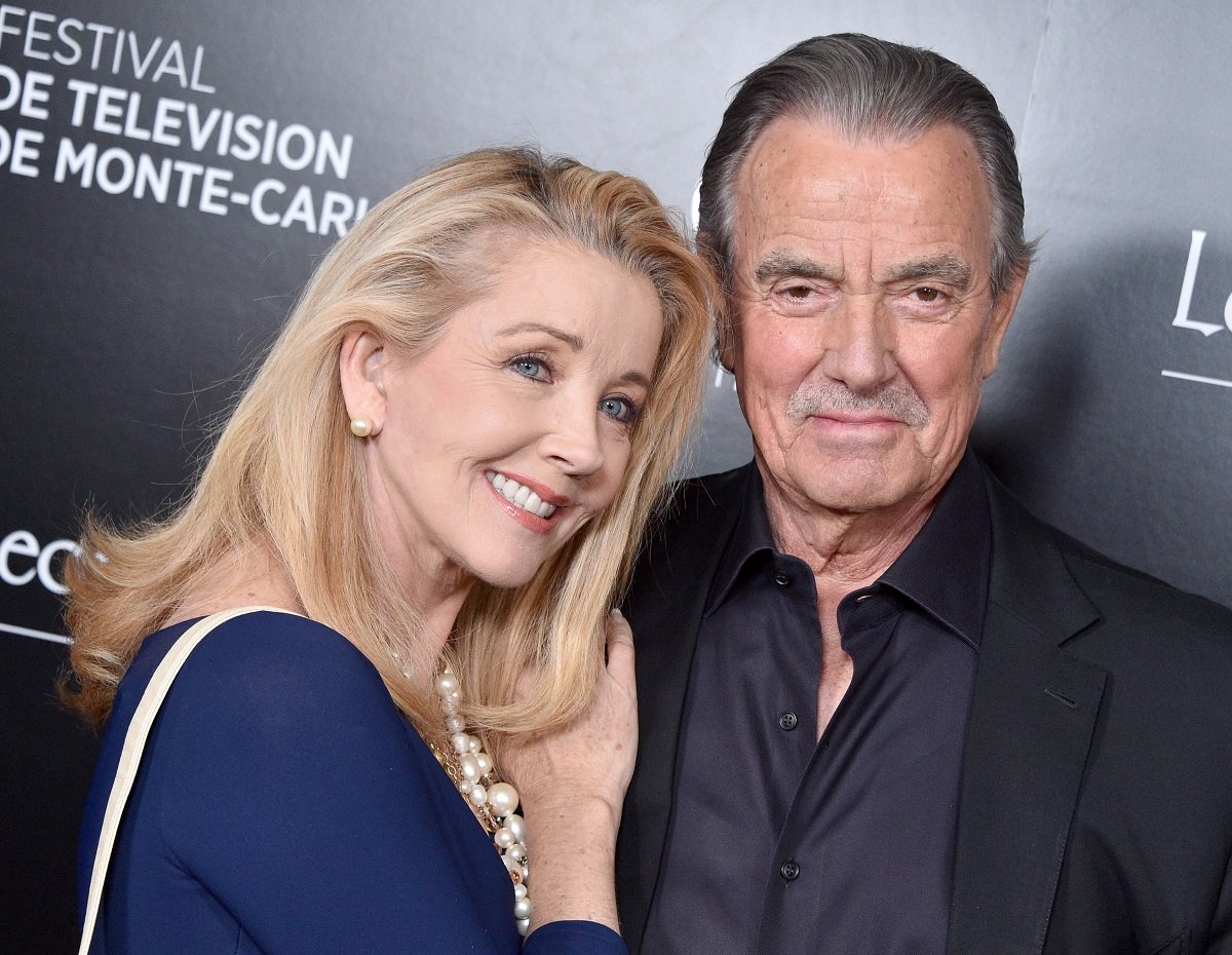 'The Young and the Restless' actor Melody Thomas Scott in a blue dress, and Eric Braeden in a black suit; share a hug.