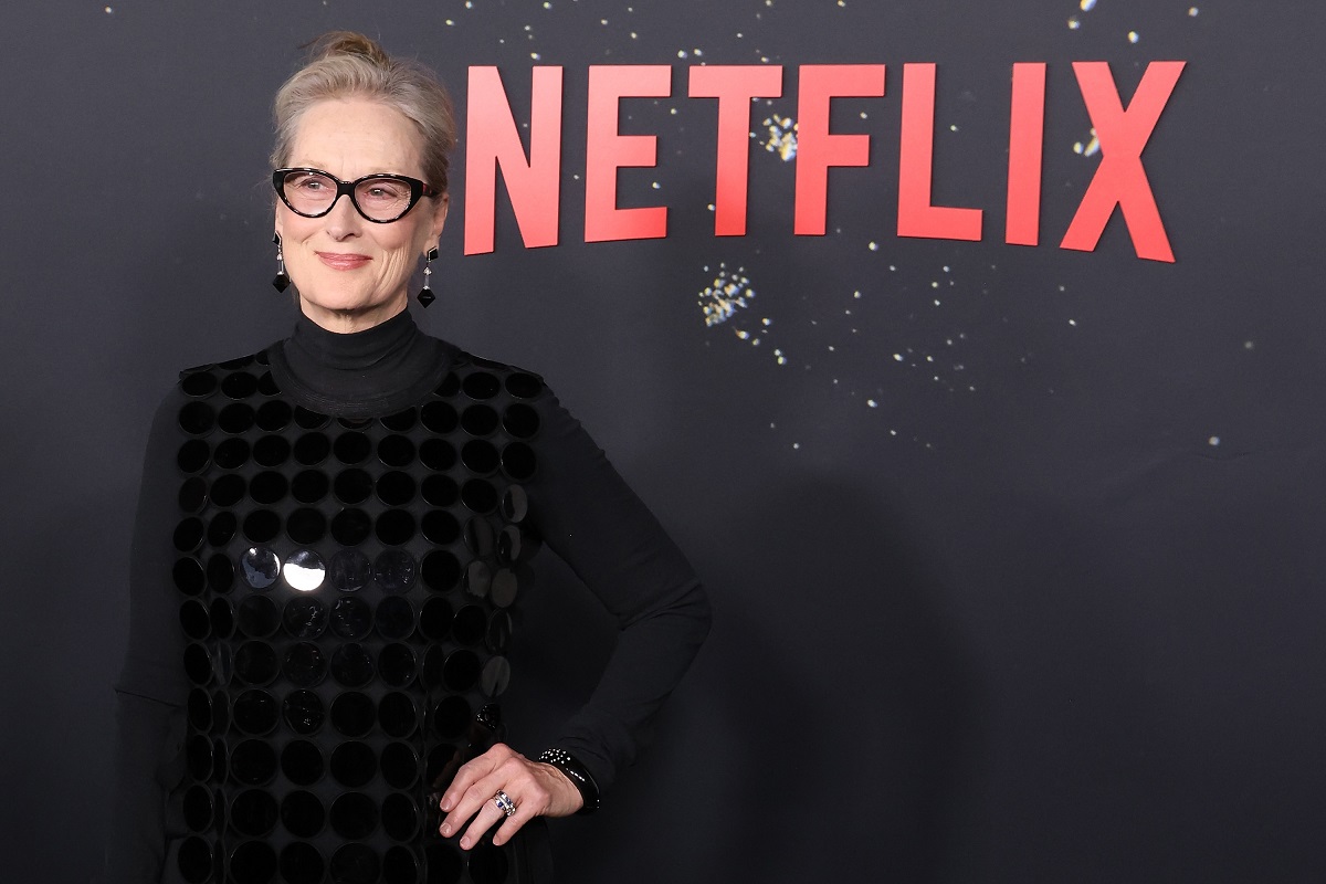 Meryl Streep smiling in a black dress.