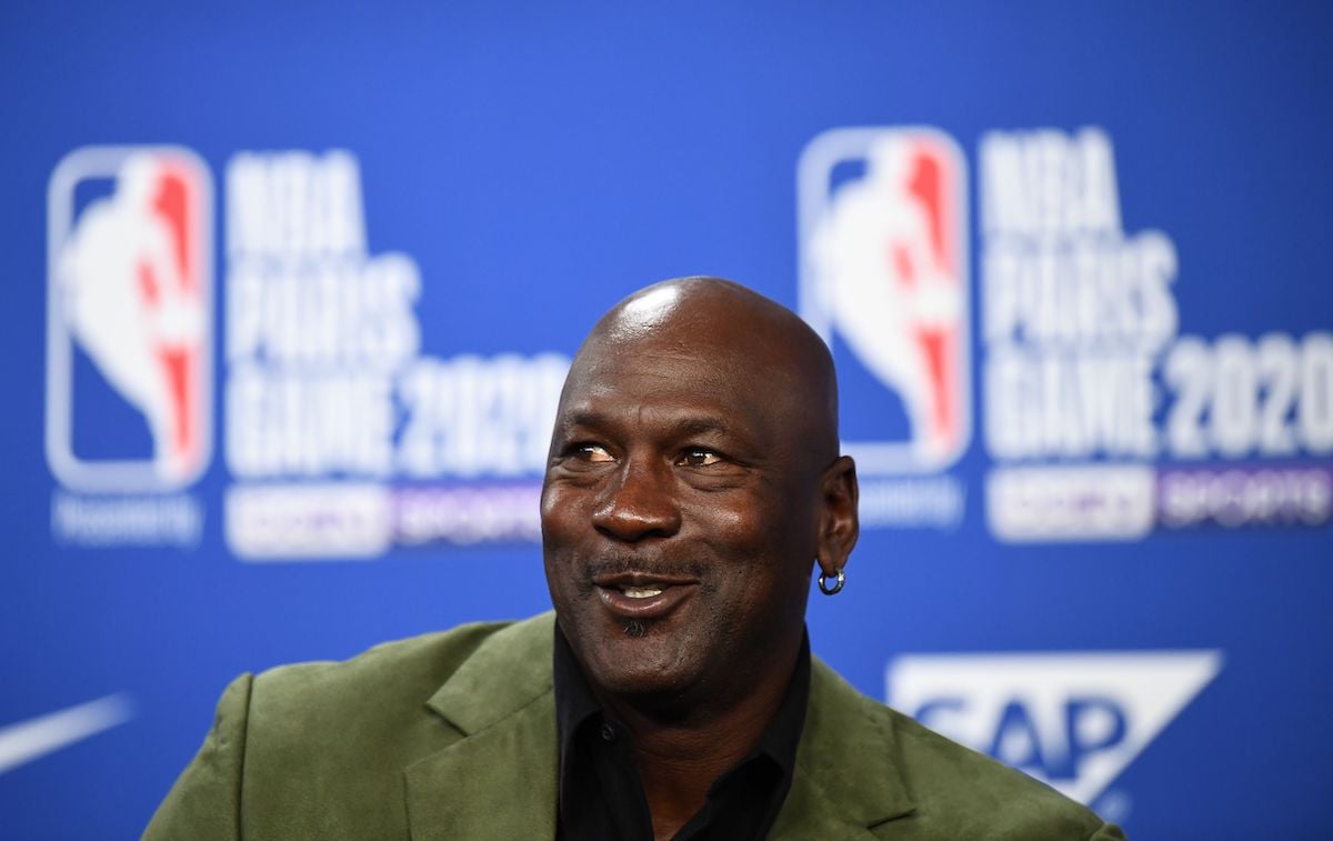 Michael Jordan smiling in front of a blue background