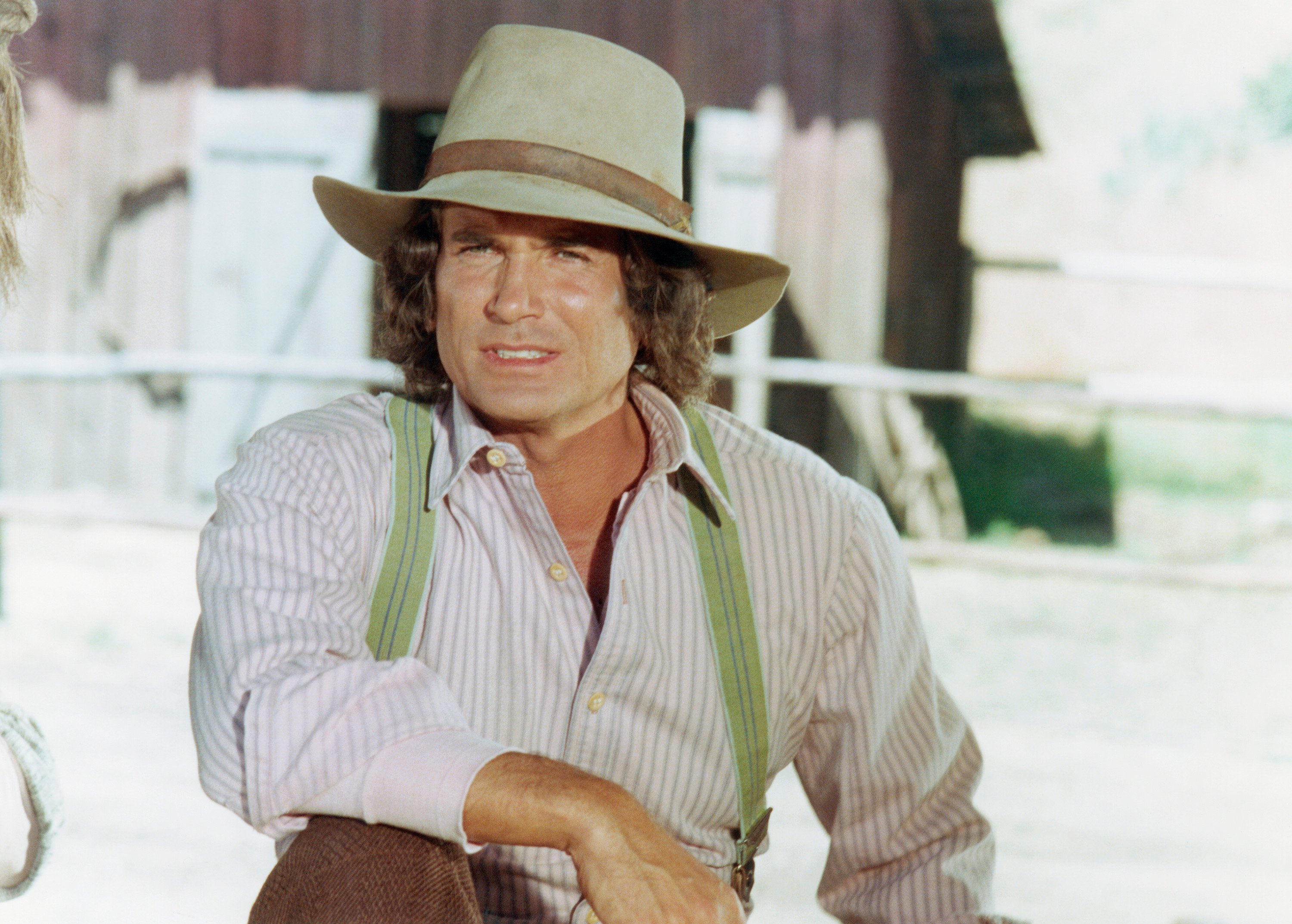 Michael Landon wears a cowboy hat while posing on the set of 'Little House on the Prairie'