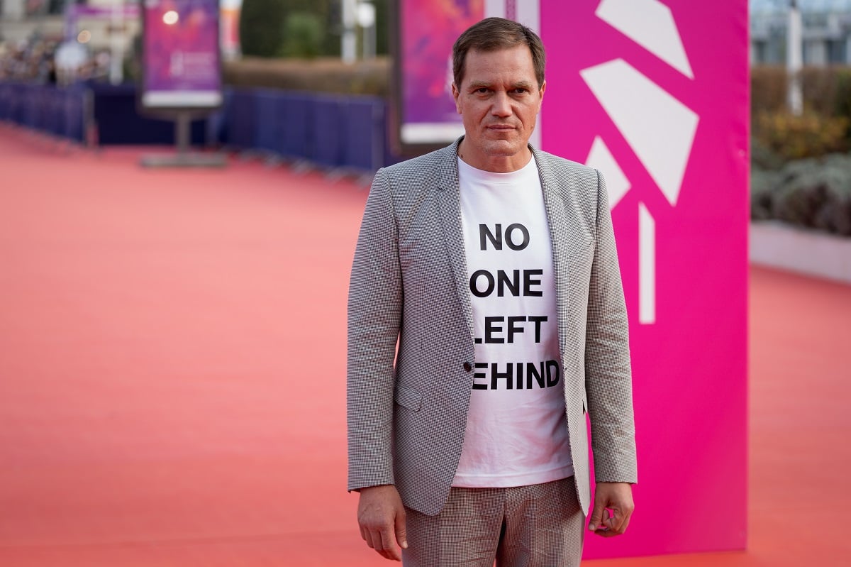 Michael Shannon posing in a gray suit.