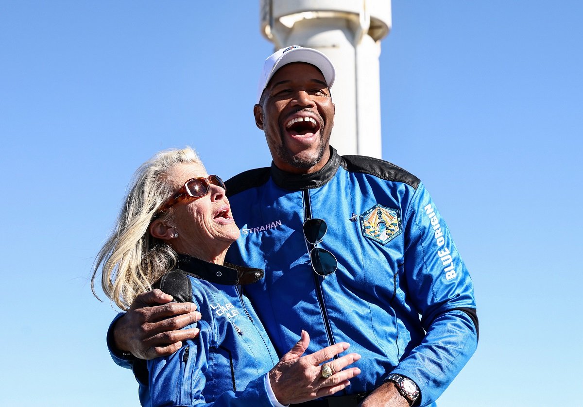 Michael Strahan laughing with Laura Shepard Churchley, who is the daughter of astronaut Alan Shepard, after their trip to space