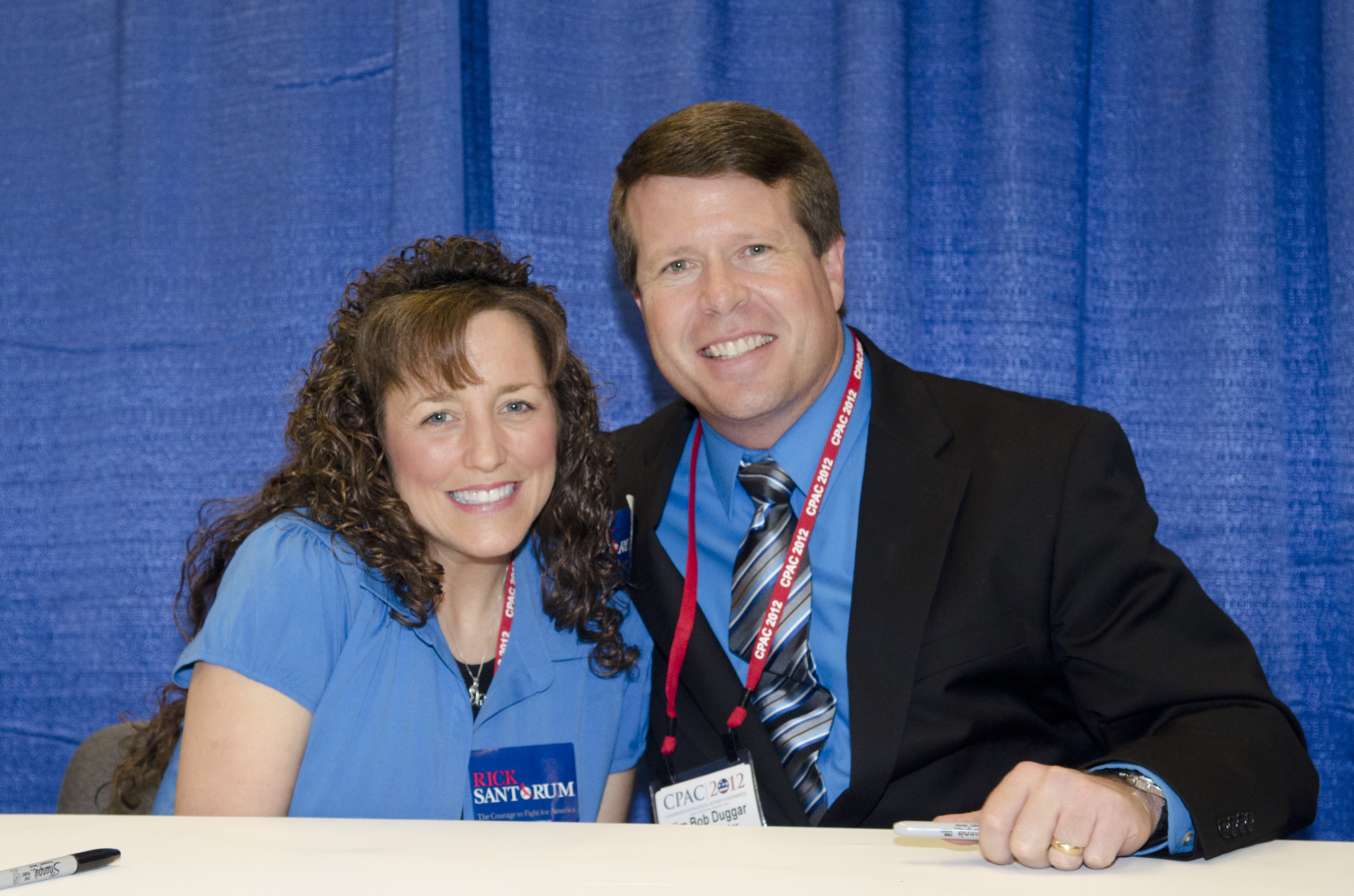 Michelle and Jim Bob Duggar smiling for the cameras an event in 2012
