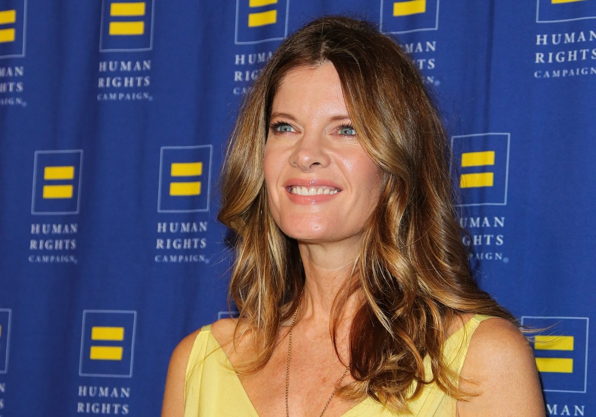 'The Young and the Restless' actor Michelle Stafford wearing a yellow dress, and posing on the red carpet.