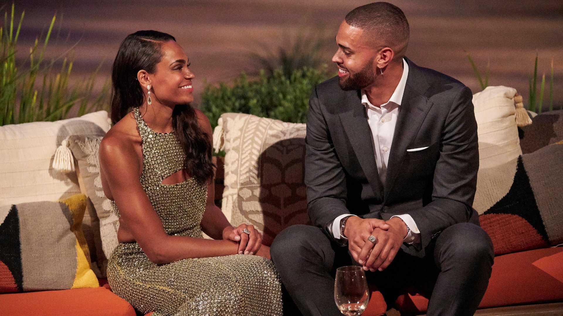 Michelle Young and Nayte Olukoya sit together and smile at each other in ‘The Bachelorette’ Season 18 in 2021