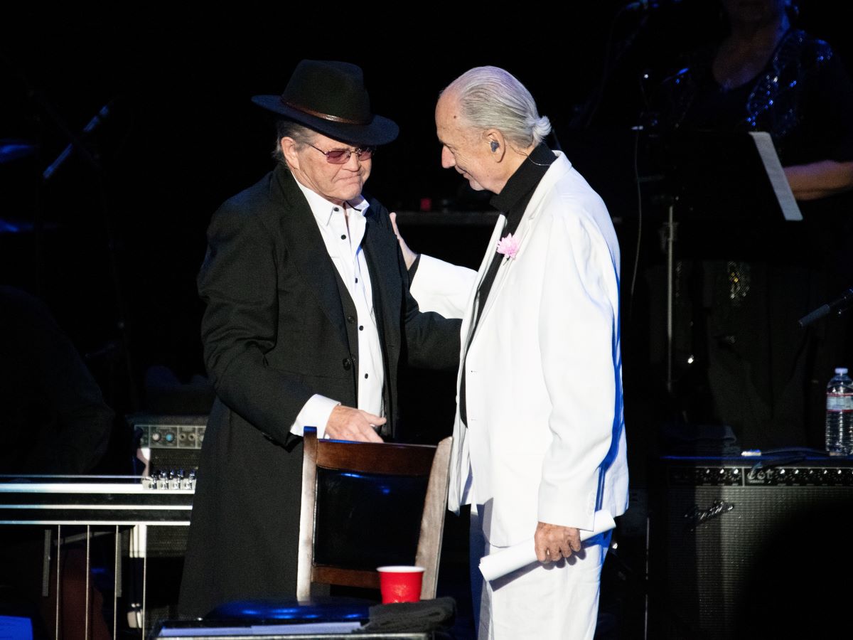 Micky Dolenz in black and Michael Nesmith in white, on stage for their last show
