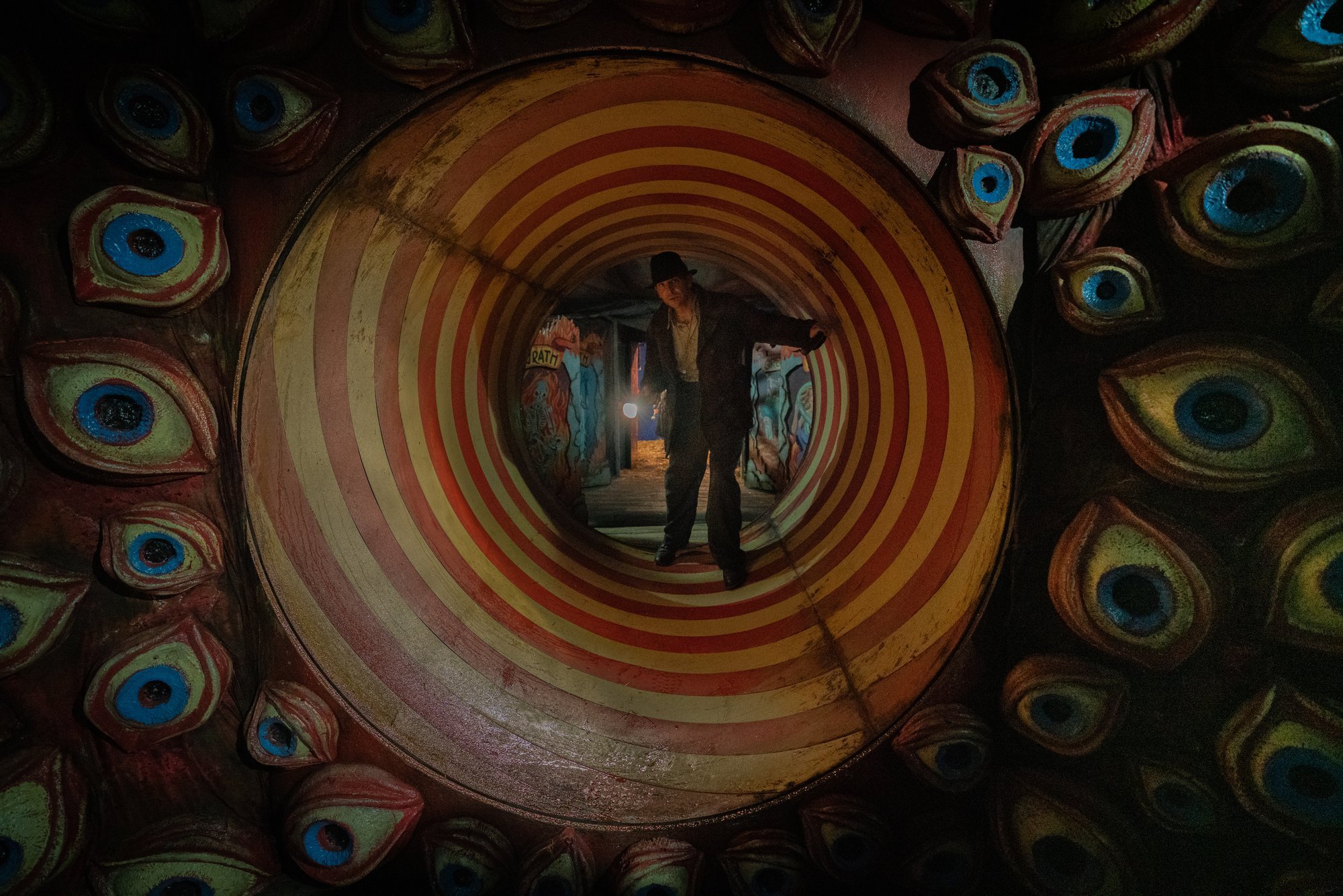 'Nightmare Alley' Bradley Cooper as Stanton Carlisle standing inside a carnival spiral tunnel
