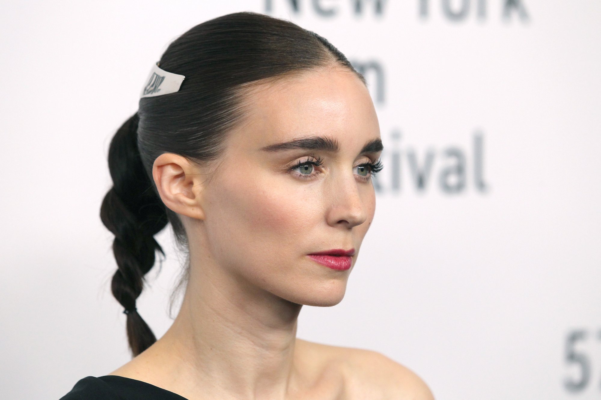 'Nightmare Alley' actor Rooney Mara from a side angle in front of a step and repeat