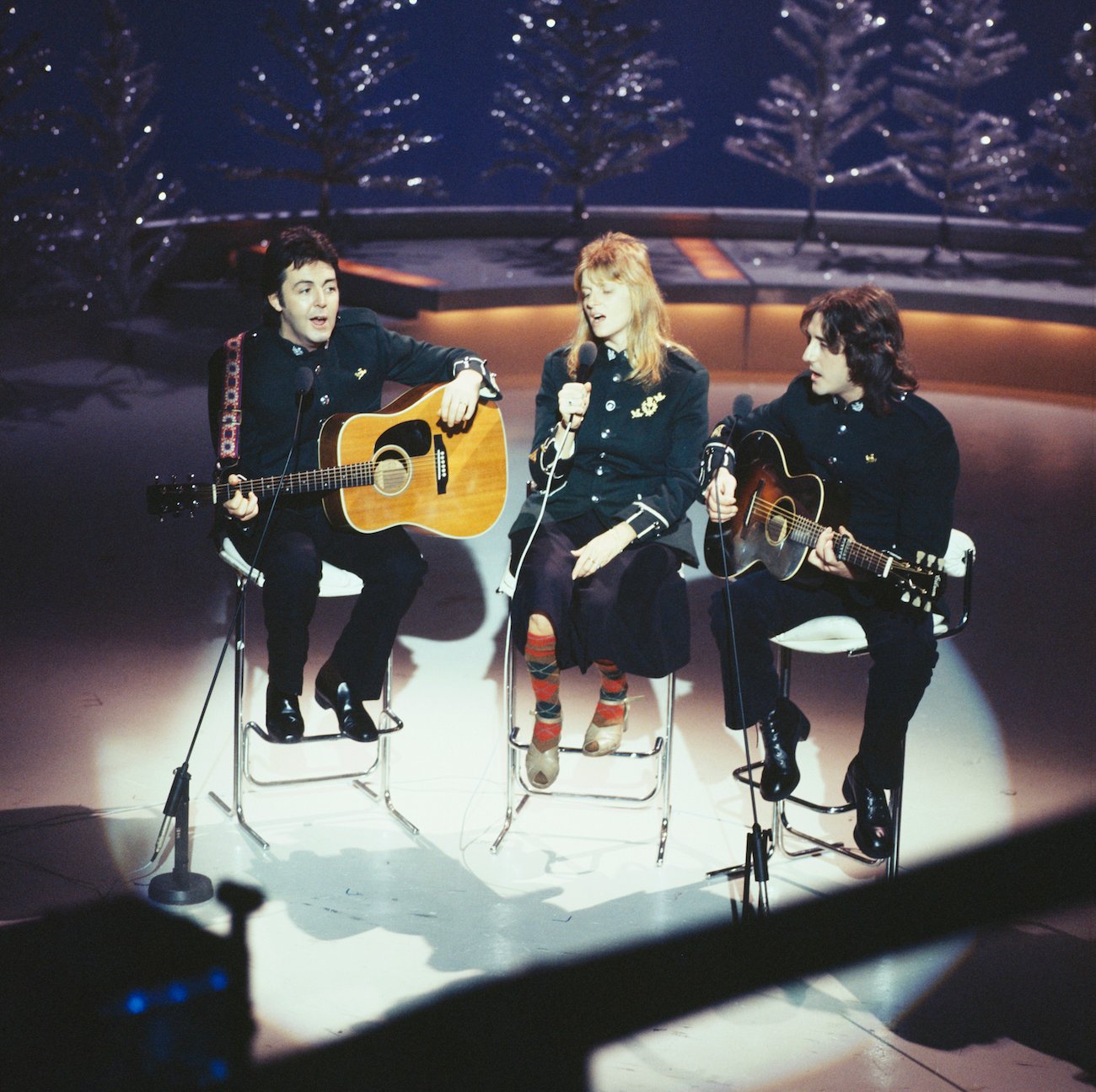 Paul McCartney, his wife, Linda, and Denny Laine performing during a BBC Christmas special in 1977.