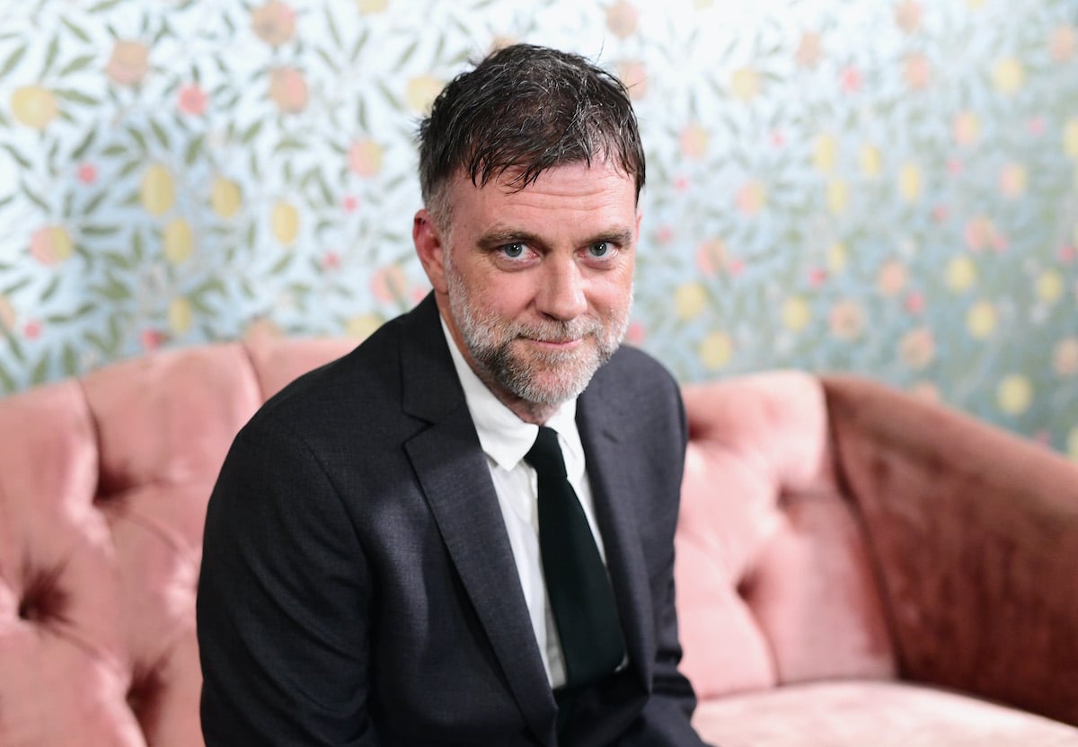 Paul Thomas Anderson smiling in front of a blue background