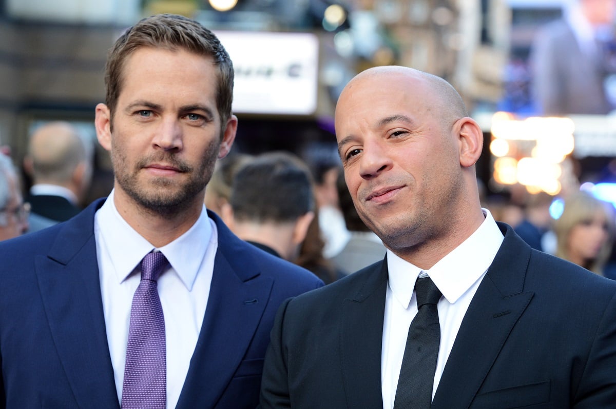 Paul Walker and Vin Diesel posing while wearing suits