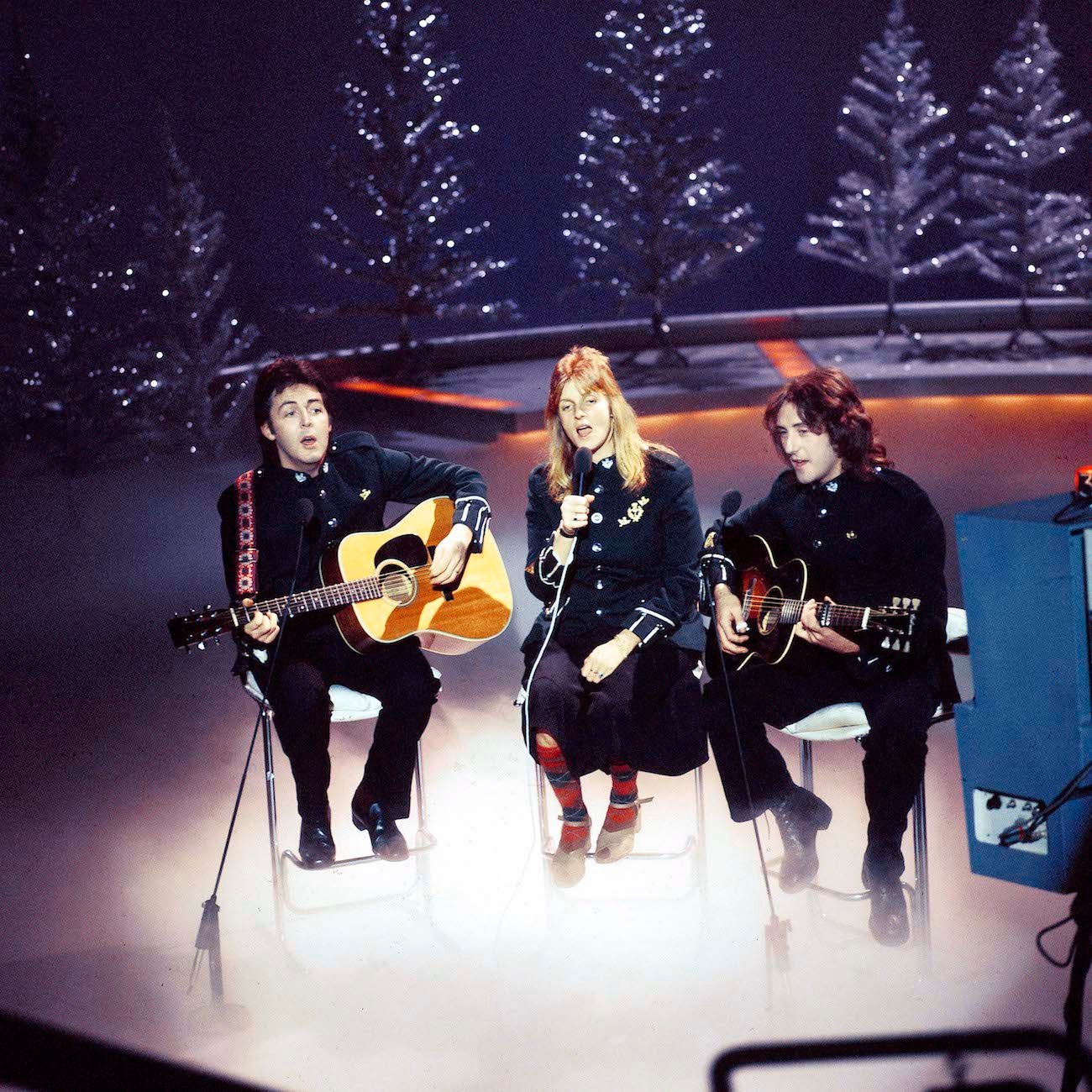 Paul McCartney and his wife, Linda McCartney, performing with Wings' Denny Laine during a BBC Christmas special in 1977.