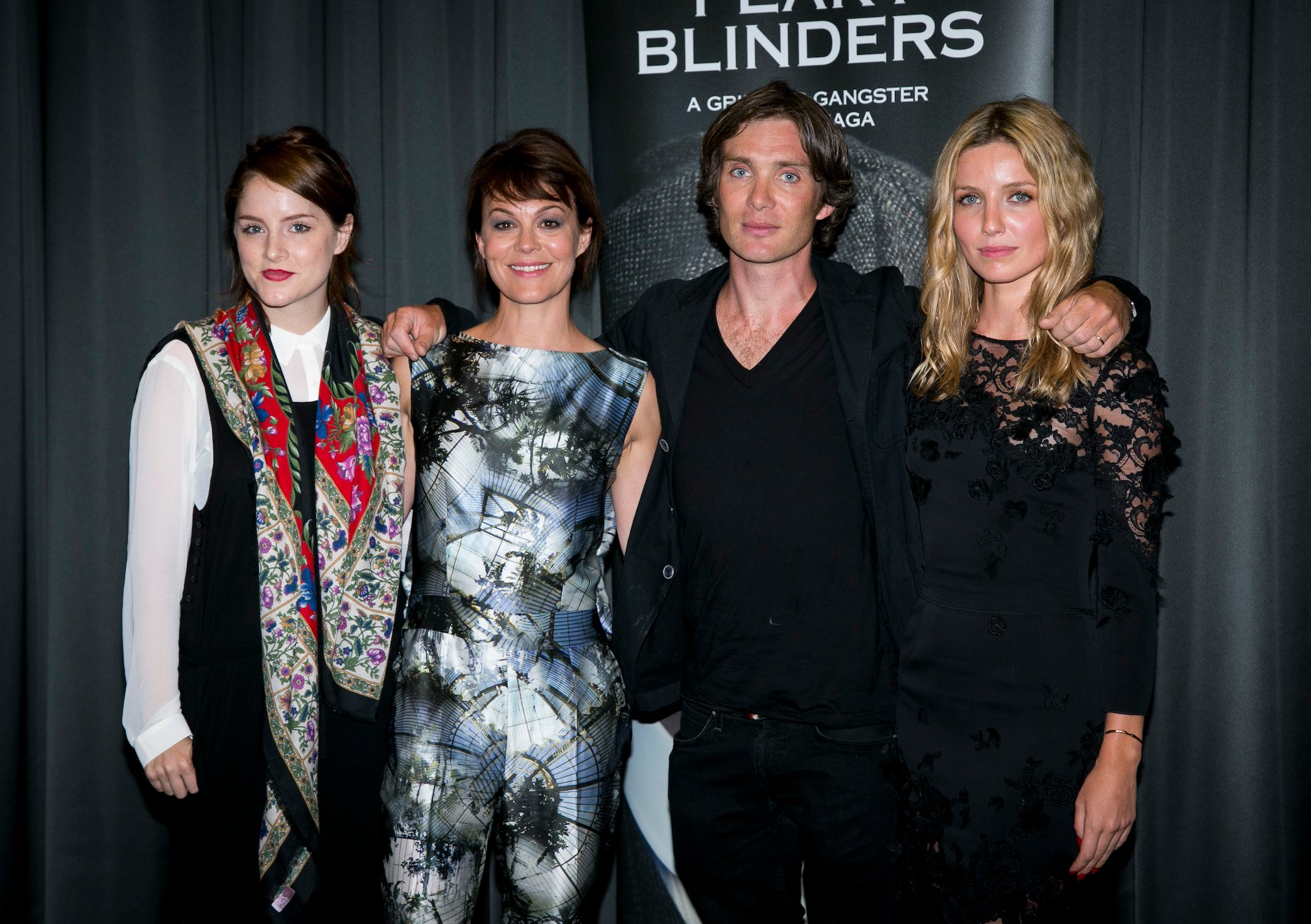 Sophie Rundle, Helen McCrory, Cillian Murphy and Annabelle Wallis from 'Peaky Blinders' Season 6 standing together and smiling at a premiere for an earlier season