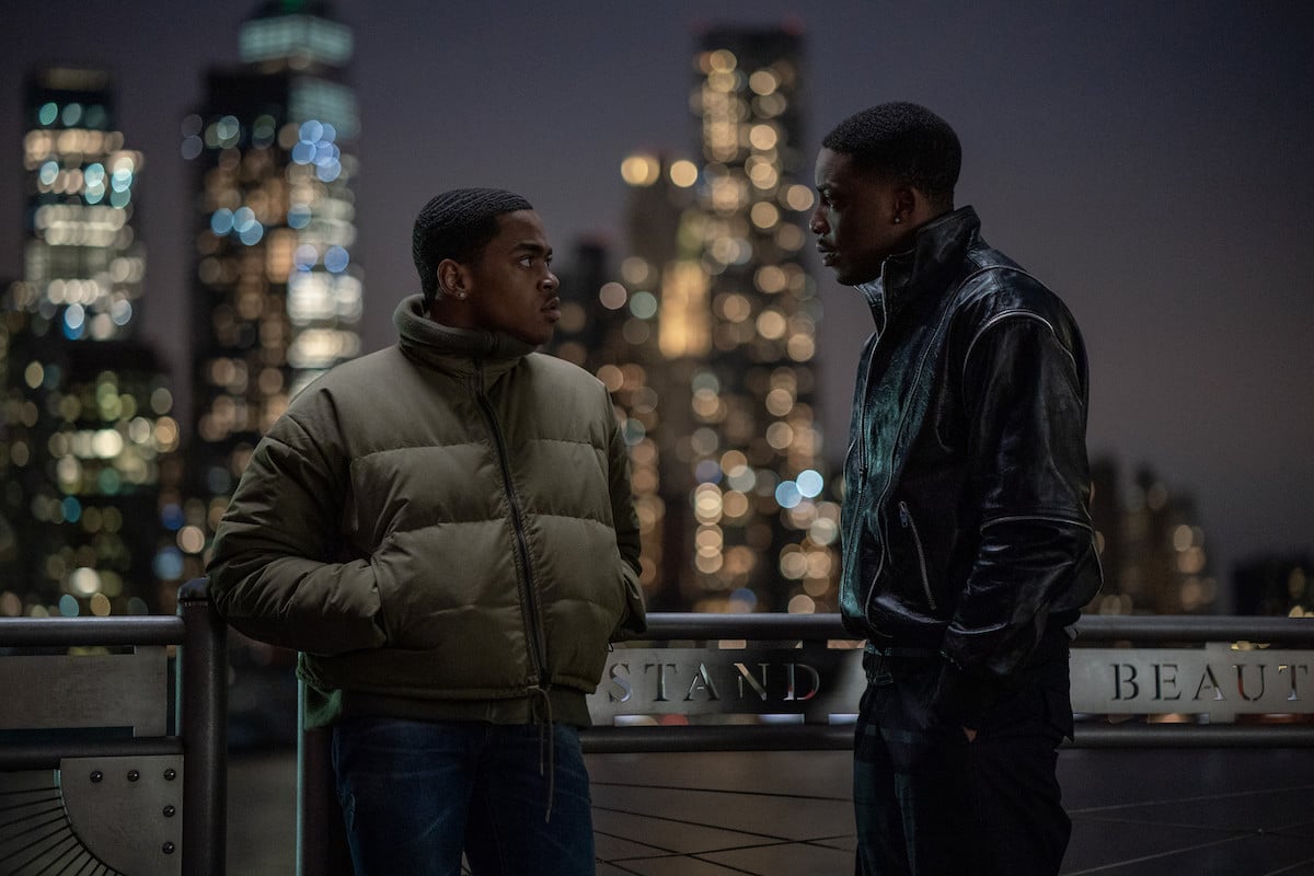 Michael Rainey Jr. as Tariq St. Patrick and Woody McClain as Cane Tejada speaking outside with the skyline in the background in 'Power Book II: Ghost'