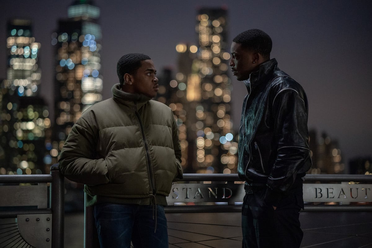 Michael Rainey Jr. as Tariq St. Patrick and Woody McClain as Cane Tejada speaking outside with the skyline in the background in 'Power Book II: Ghost' 