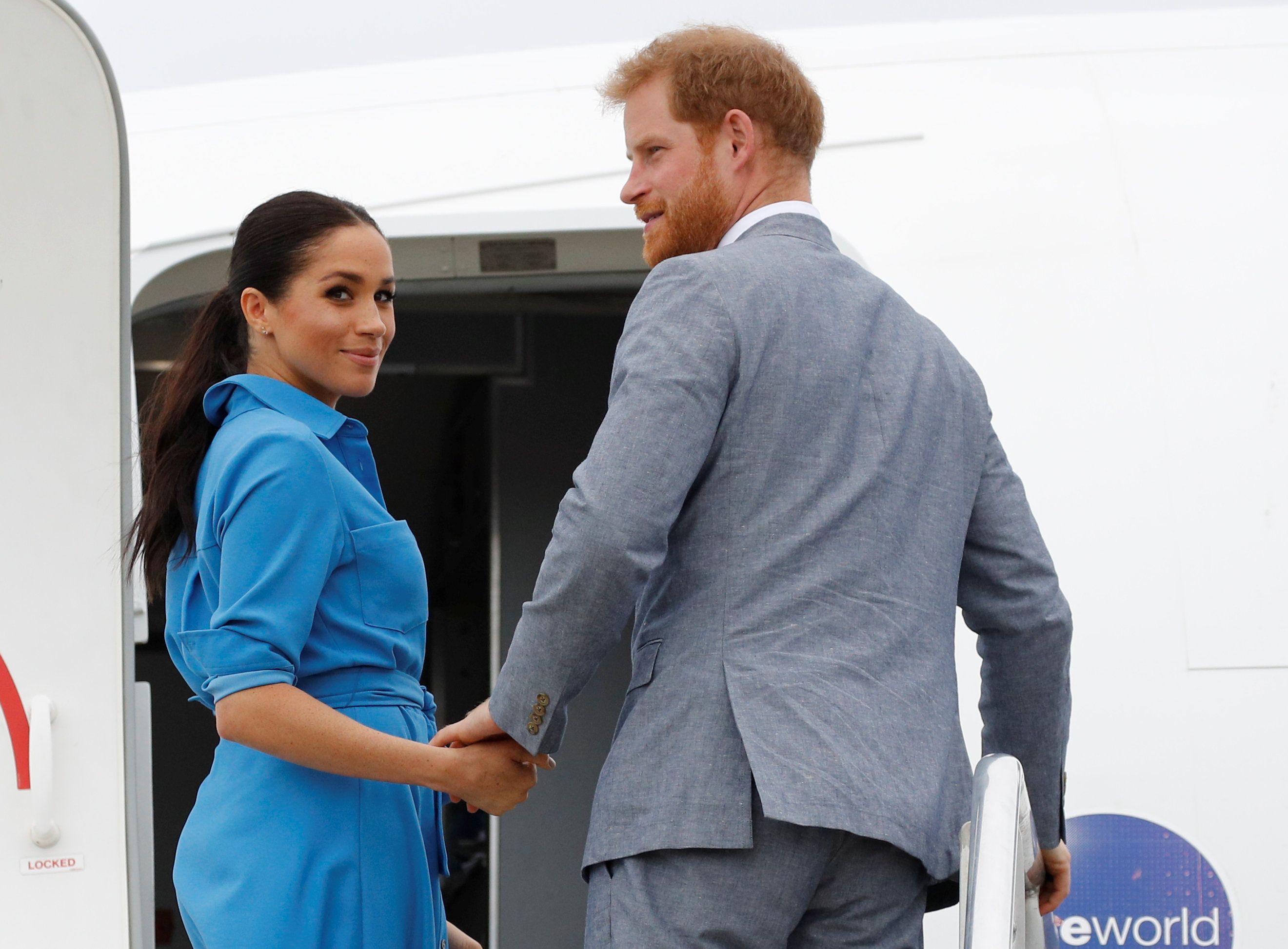 Prince Harry and Meghan Markle departing from Fua'amotu International Airport