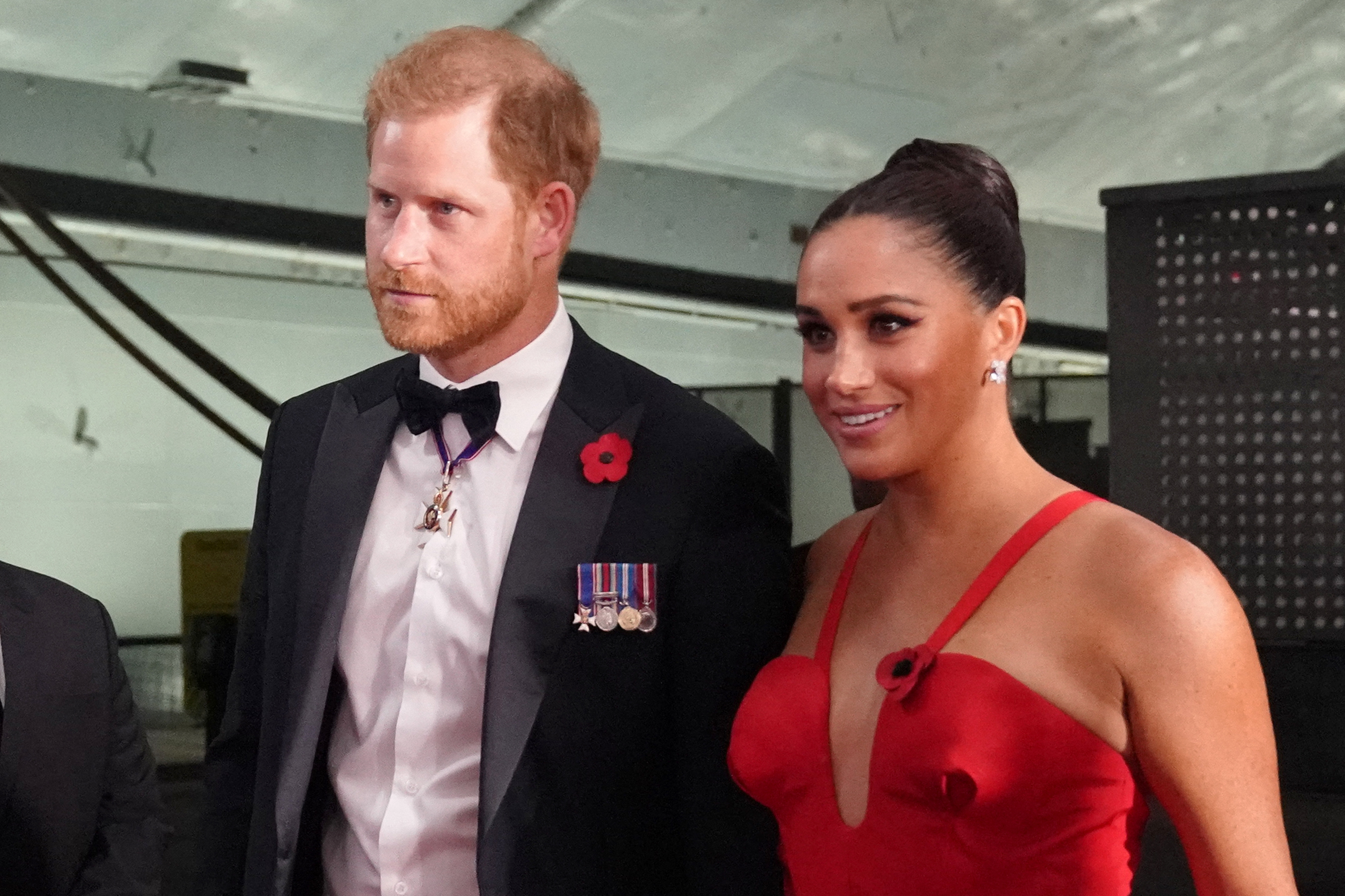 Prince Harry in a tuxedo and Meghan Markle in red gown at the Intrepid Valor Awards