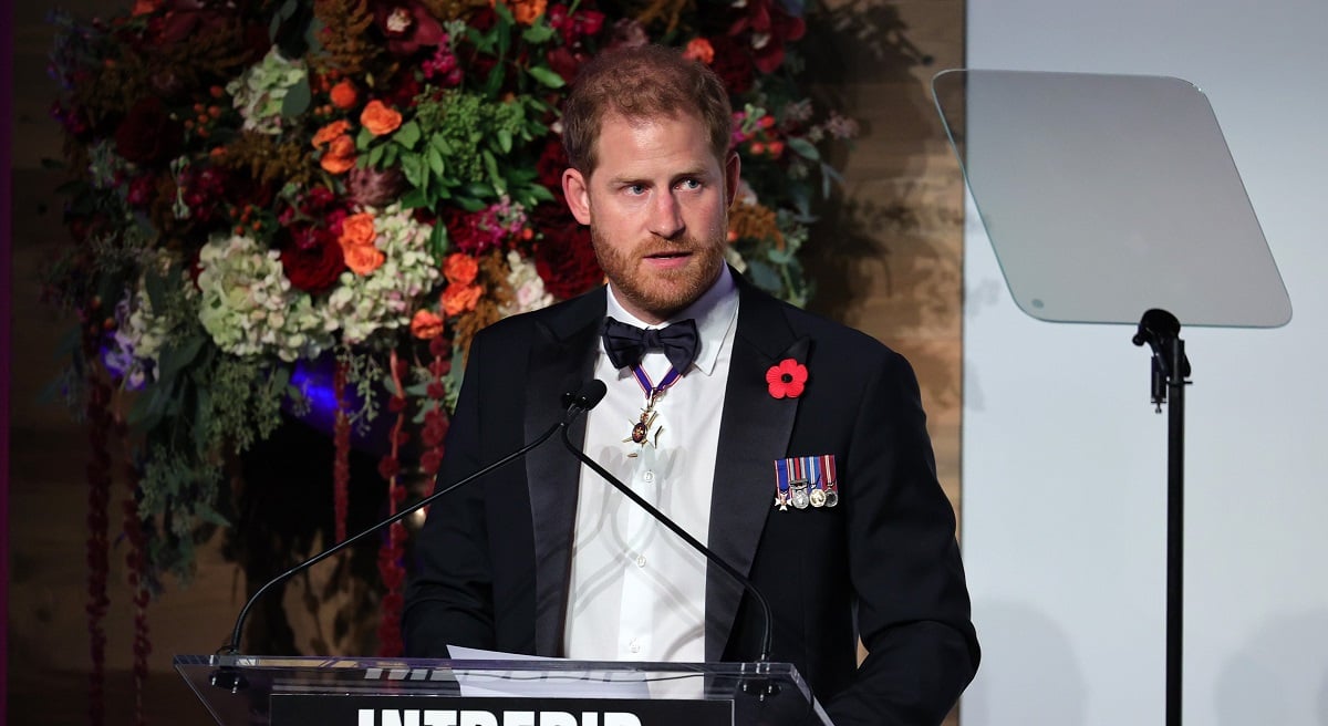 Prince Harry in a tuxedo as he speaks on stage as Intrepid Museum