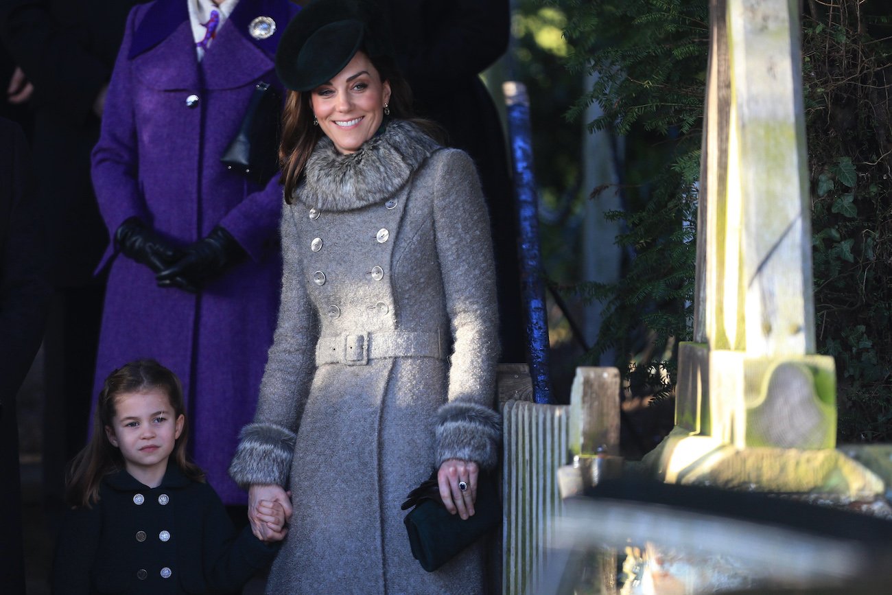 Kate Middleton holds Princess Charlotte's hand