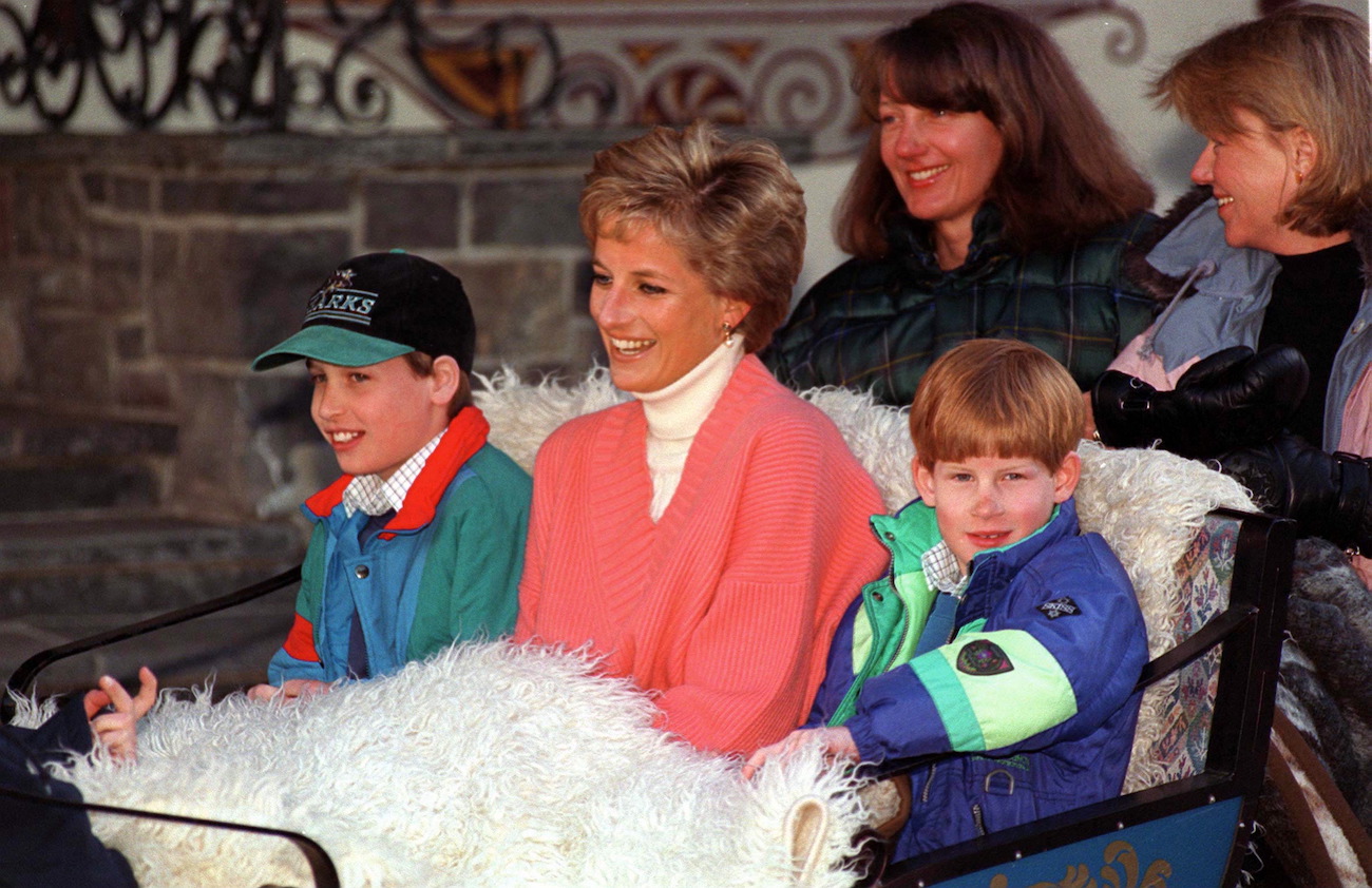 Princess Diana sitting with Prince William and Prince Harry on a sleigh ride