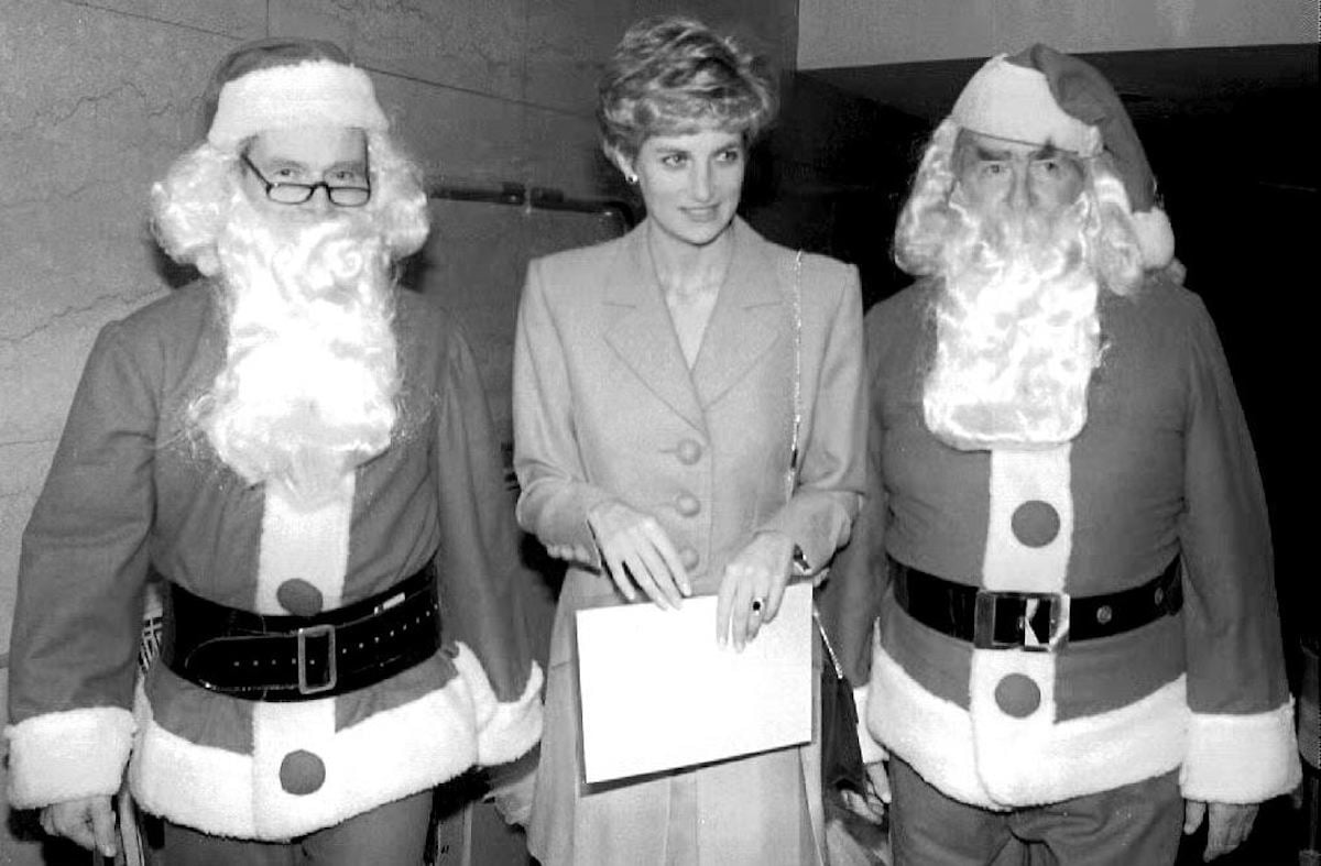 Flanked by two Santas, Princess Diana, patron of Headway, the National Head Injuries Association, attends a lunch on December 10, 1992 in London