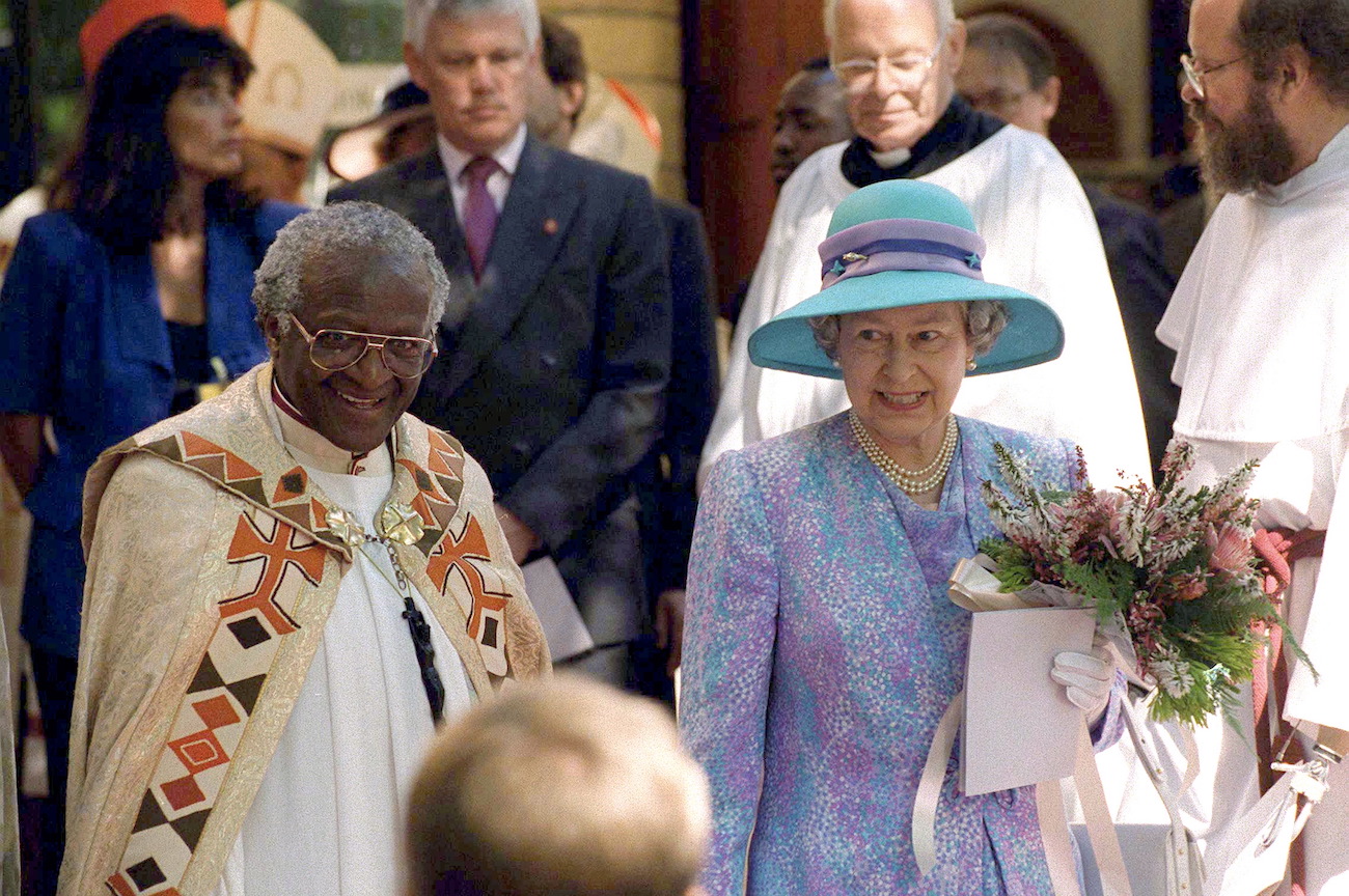 Desmond Tutu and Queen Elizabeth in a crowd of people during Queen Elizabeth's visit to South Africa in 1995