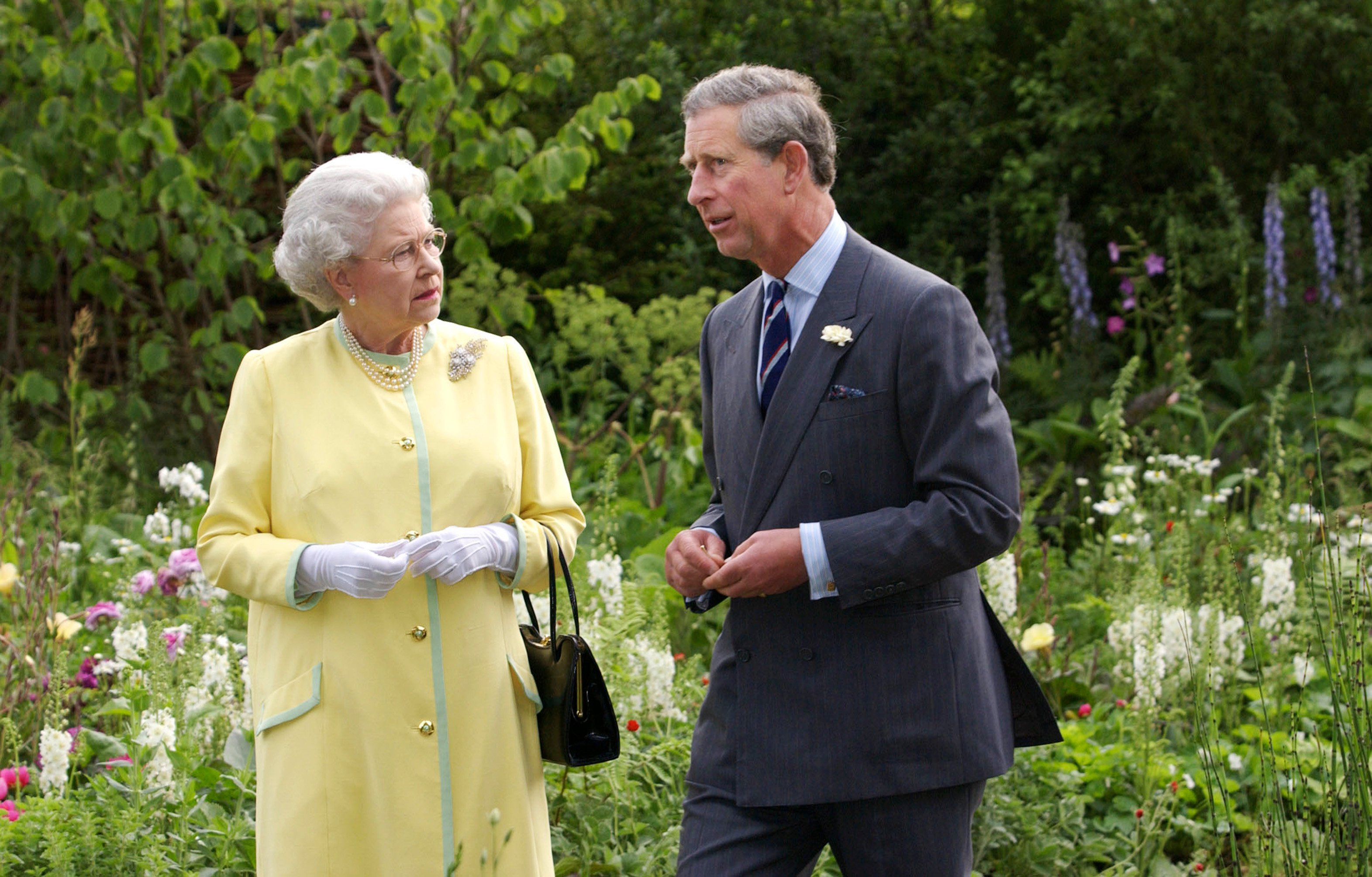 Queen Elizabeth II and Prince Charles standing at the 'Healing Garden,' which honors The Queen Mother
