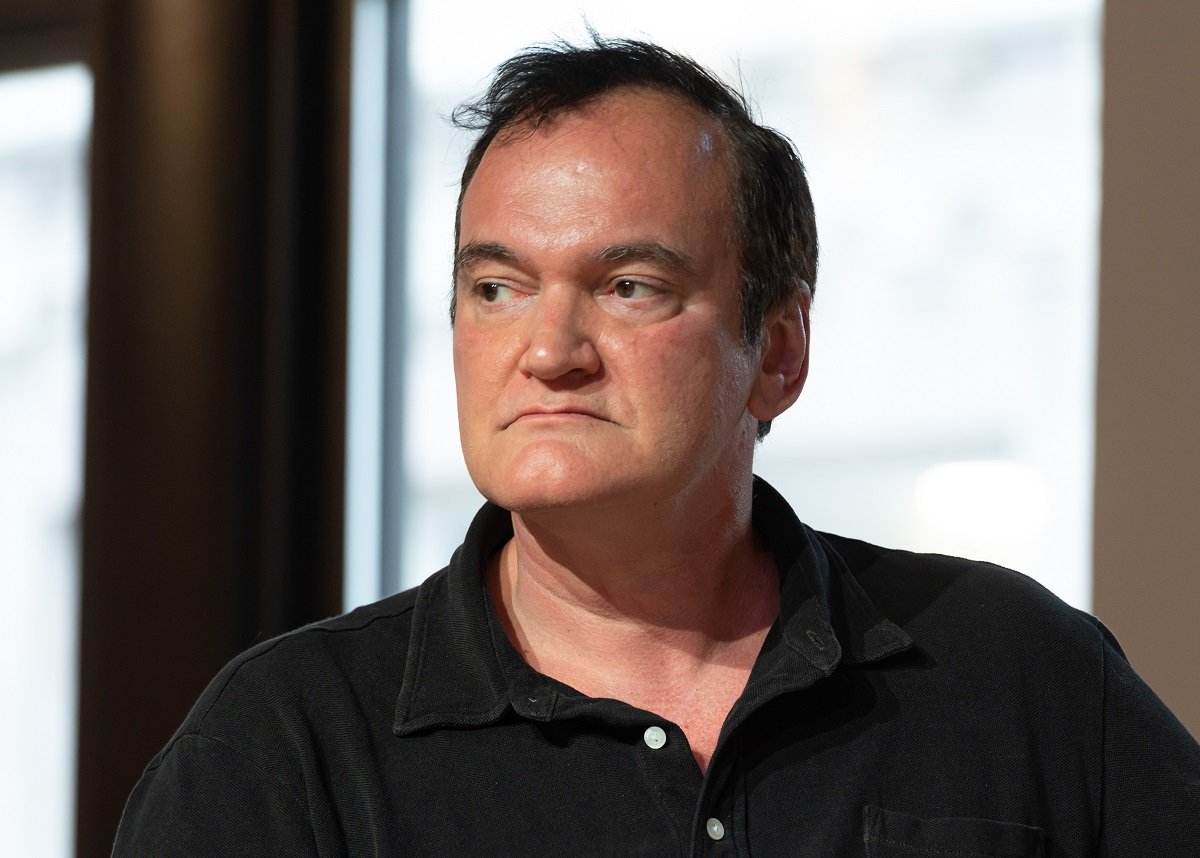 Quentin Tarantino posing in a black shirt