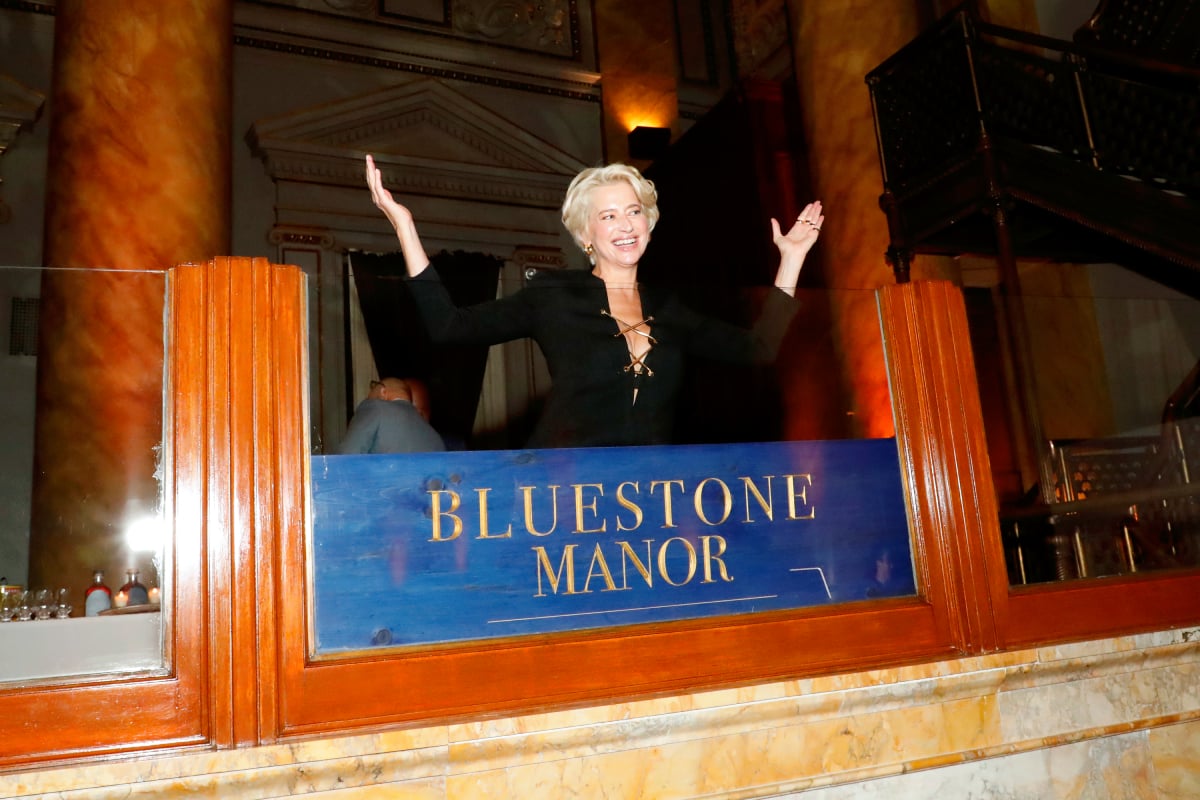 Dorinda Medley posing in front of a Bluestone Manor sign