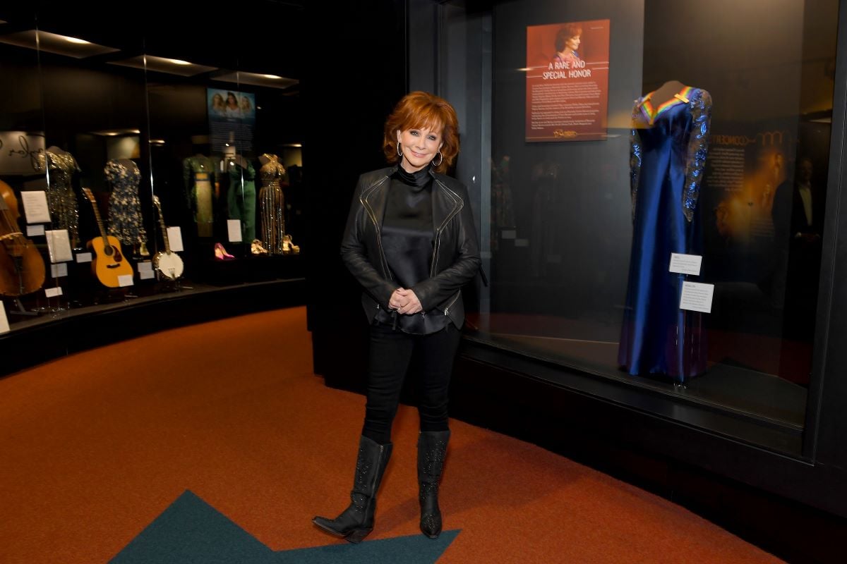 Reba McEntire dressed in a black outfit and boots