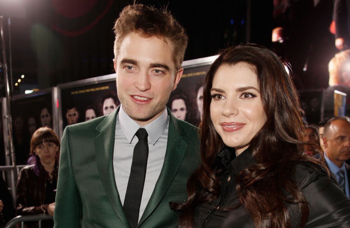 Robert Pattinson in a green suit standing next to with 'Twilight' author Stephenie Meyer