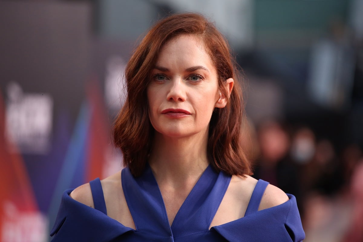 Ruth Wilson posing in a blue dress.
