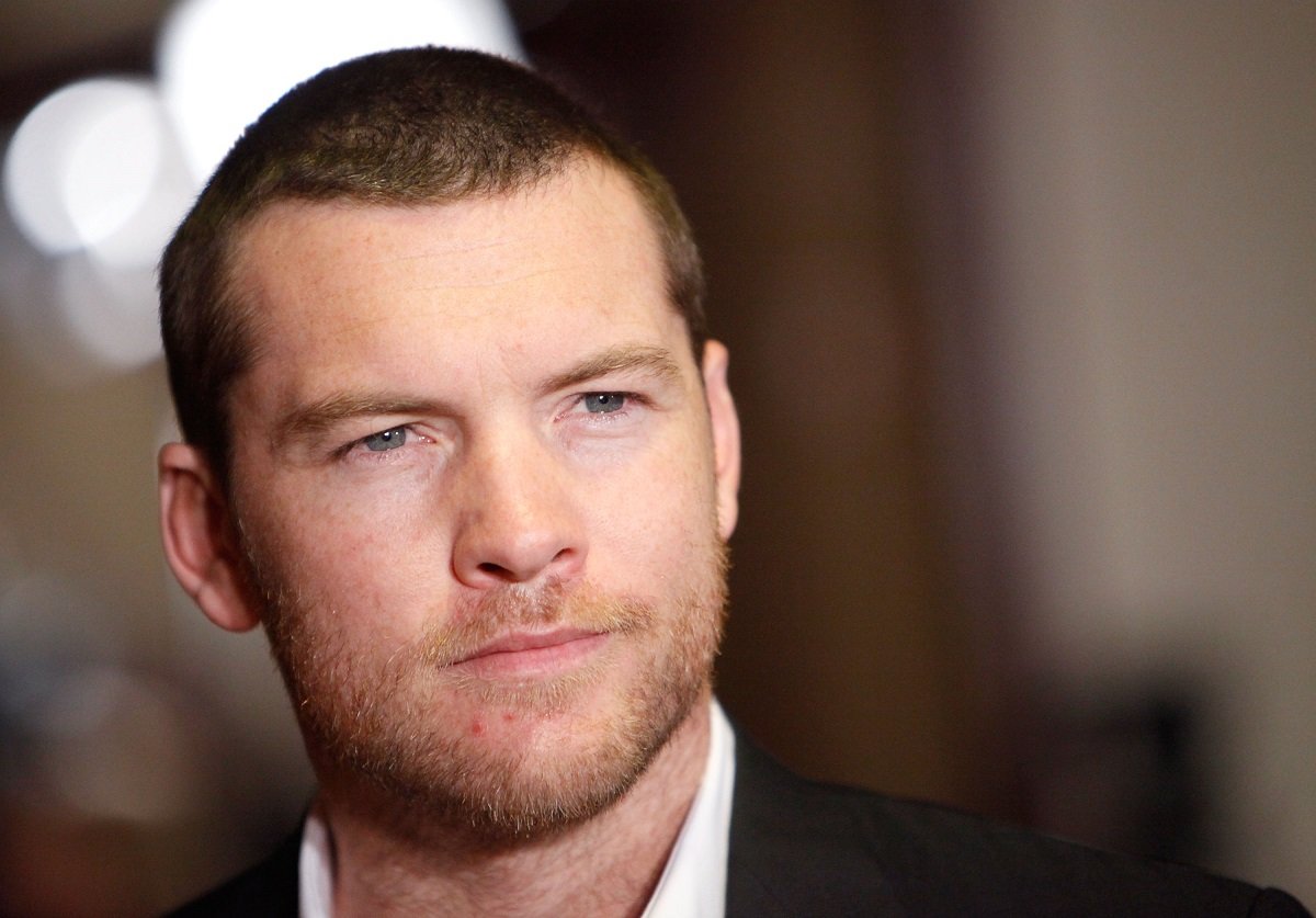 Sam Worthington posing in a suit