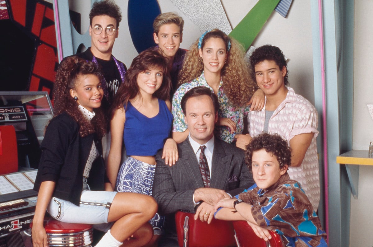 Saved by the Bell cast: Lark Voorhies (left) as Lisa Turtle, Ed Alonzo as Max, Tiffani Thiessen as Kelly Kapowski, Mark-Paul Gosselaar as Zack Morris, Dennis Haskins as Mr. Richard Belding, Elizabeth Berkley as Jessie Spano, Dustin Diamond as Screech Powers, and Mario Lopez as A.C. Slater