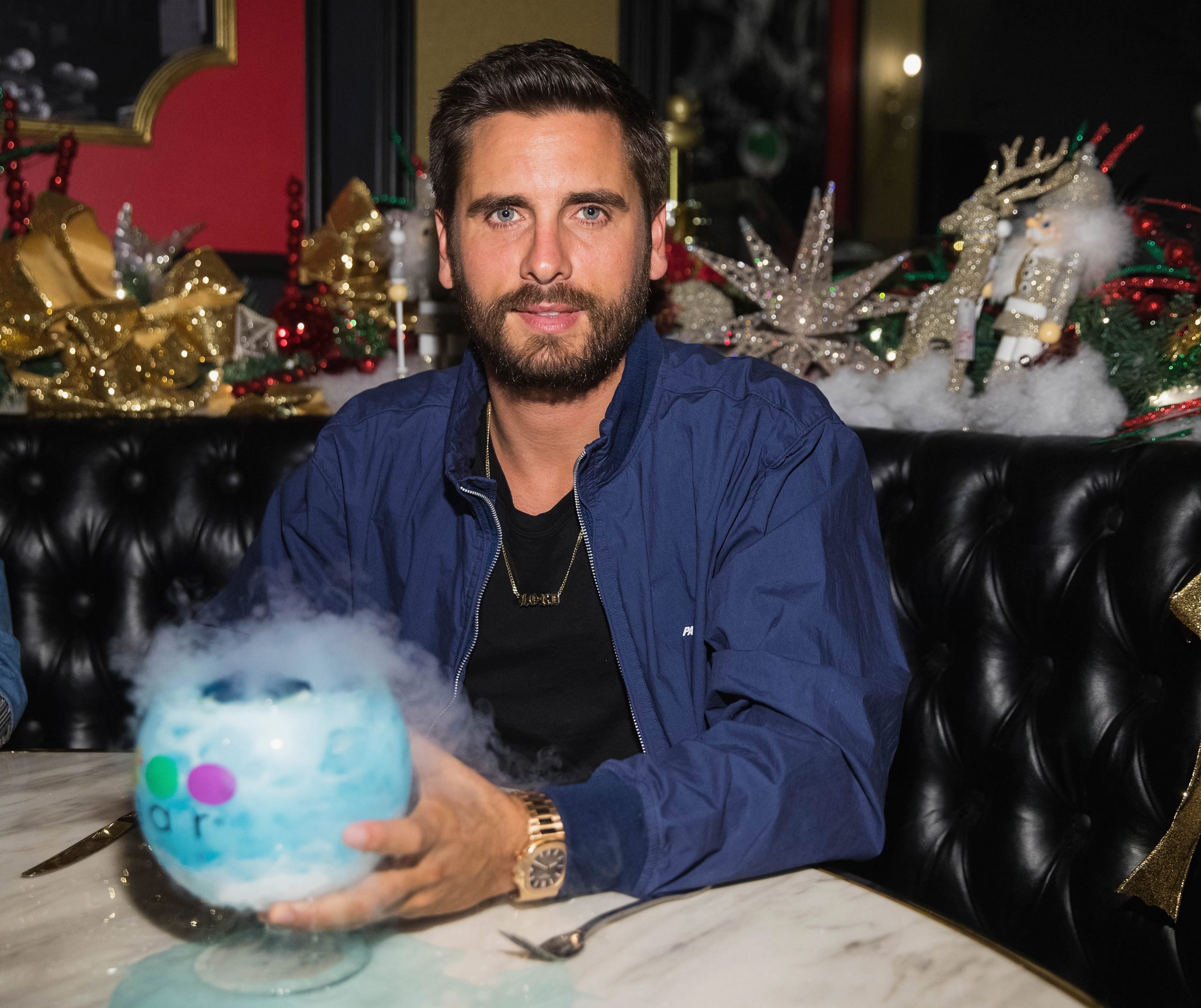 Scott Disick poses with a drink.