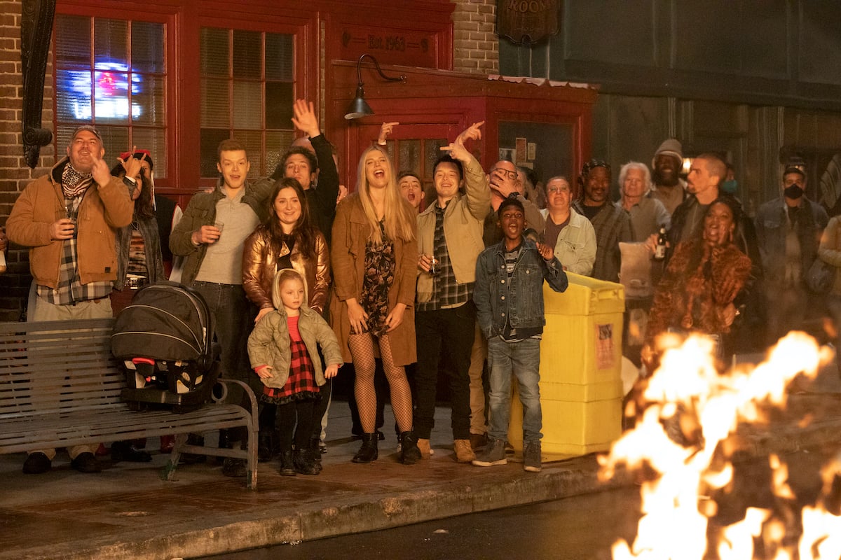 'Shameless' cast in front of the Alibi Room set, with a fire in the front