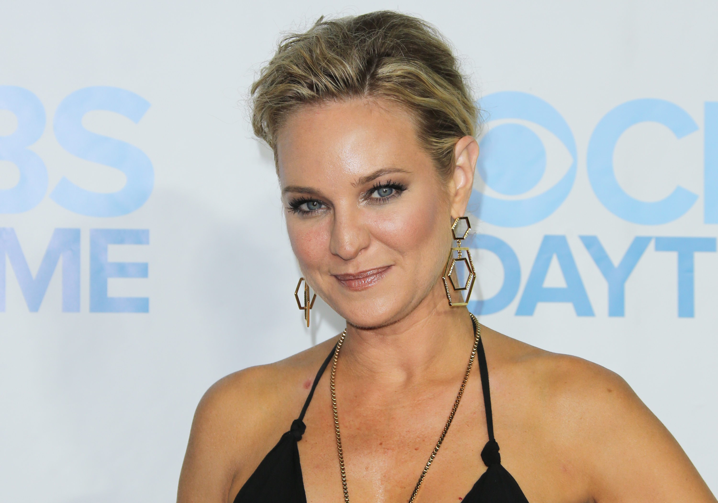 'The Young and the Restless' actor Sharon Case wearing a black dress and sporting an updo hairstyle.