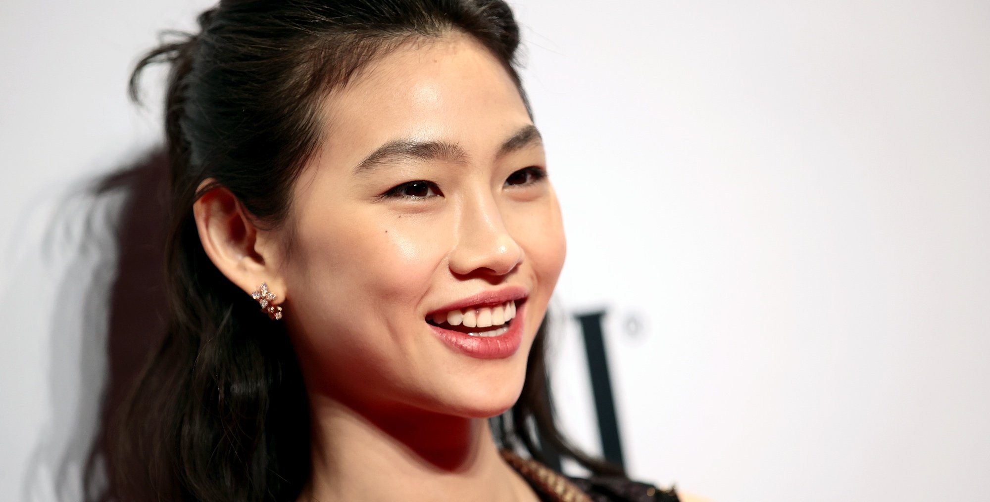 'Squid Game' actor Hoyeon Jung at awards show wearing black dress and updo.