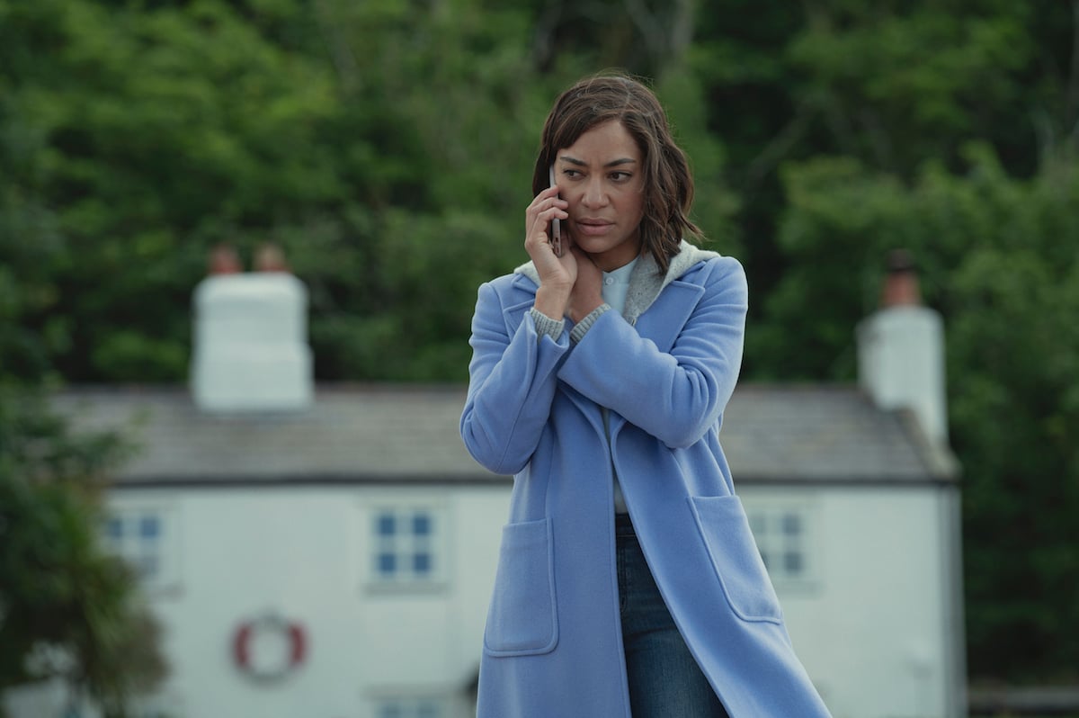 A woman, walking outside while talking on the phone, in Netflix's 'Stay Close'