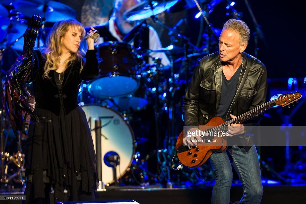 Stevie Nicks and Lindsey Buckingham perform on stage together.