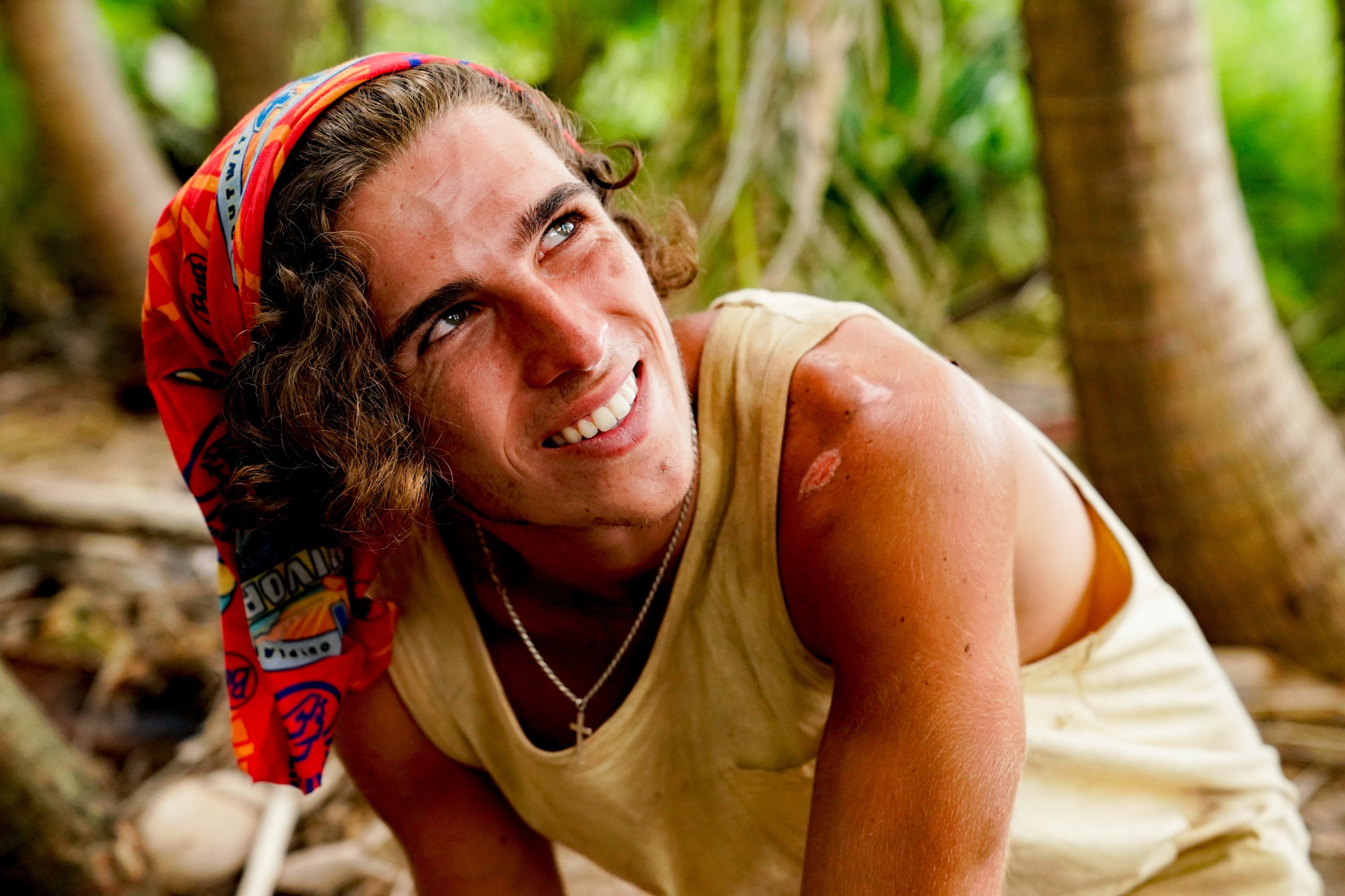 'Survivor' Season 41 castaway Xander Hastings wears a yellow tank top and a red buff on his head.